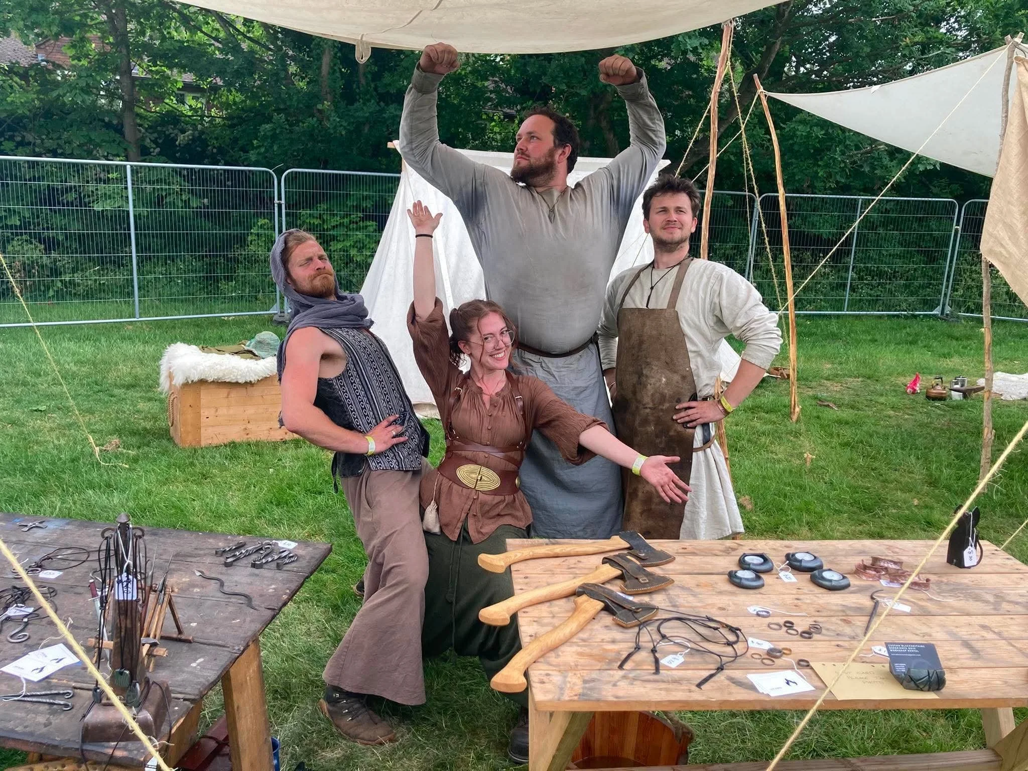 A group of blacksmiths at a Tolkien festival with their hand forged items in the foreground