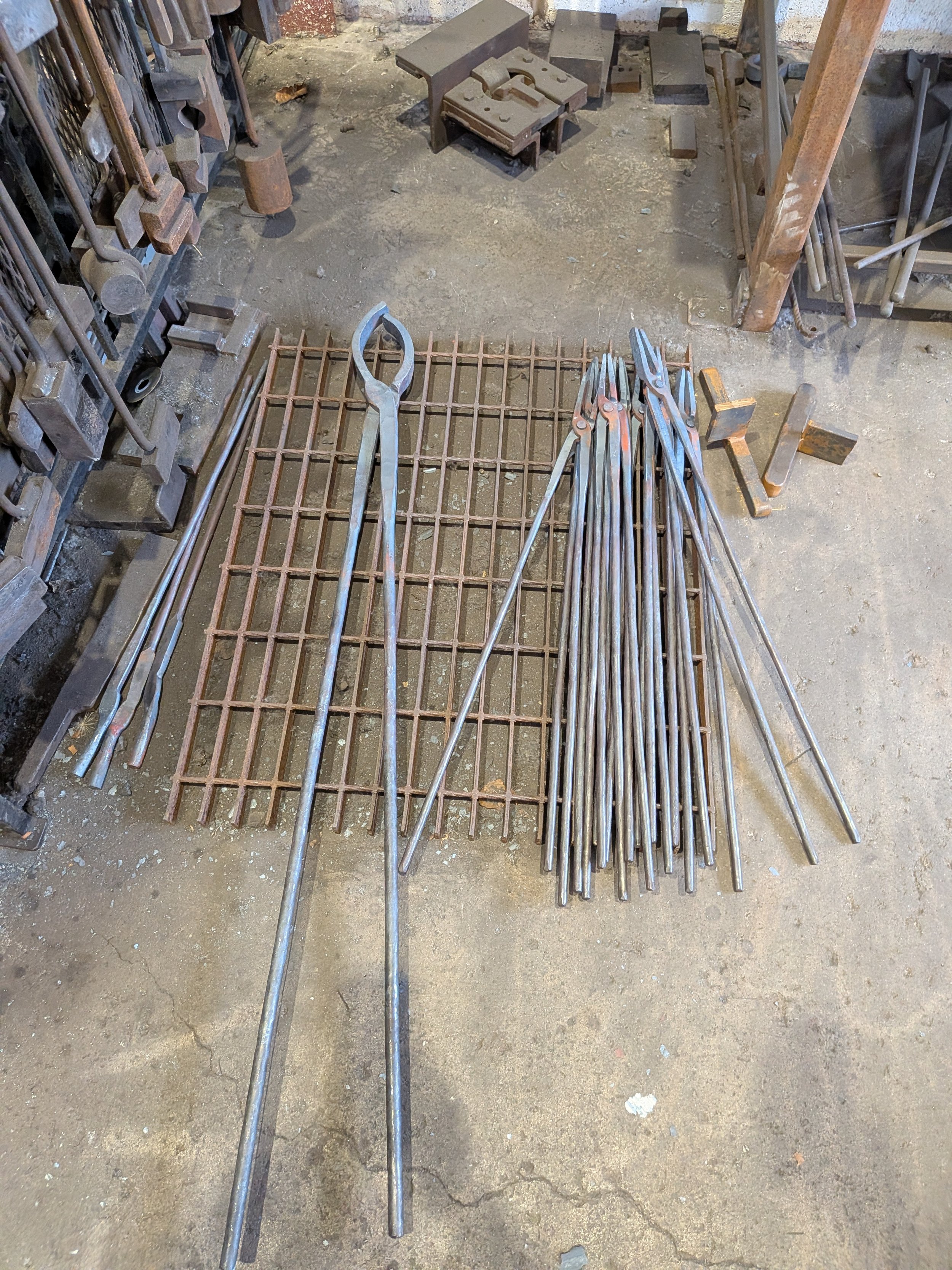A stack of handmade tongs, forged by a blacksmith