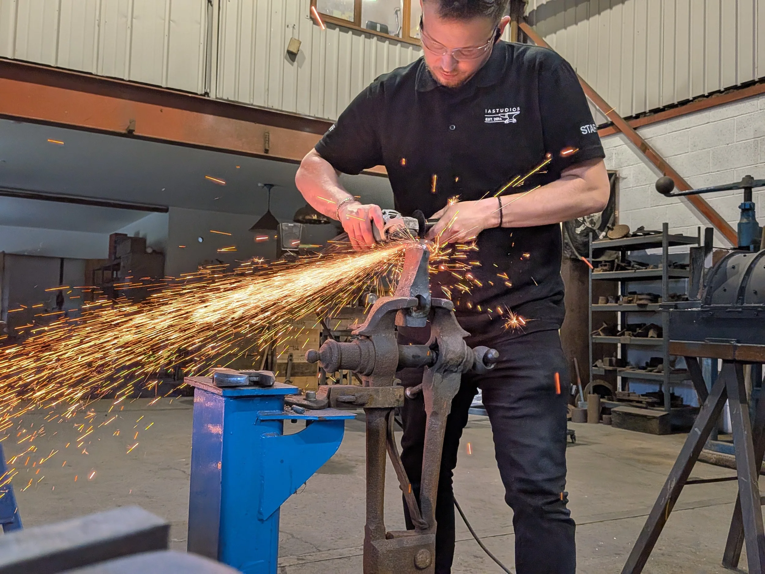 blacksmith grinding an axe