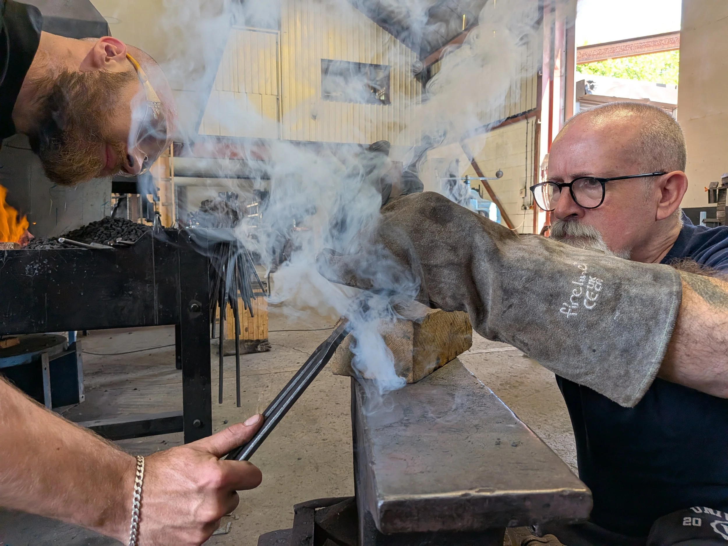 A student on a knife making course burns on their handle