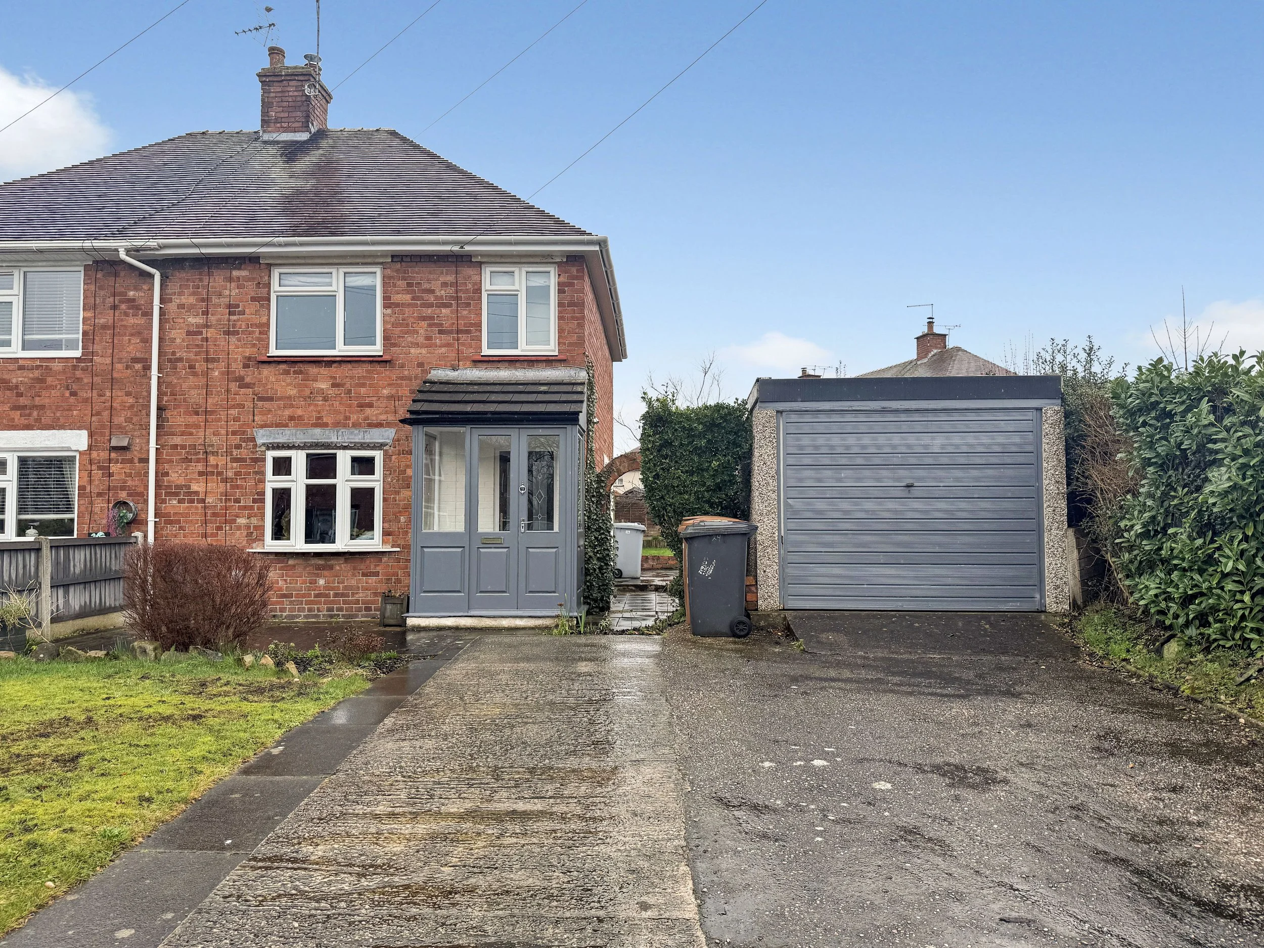 Front elevation of two bedroom semi-detached house for sale on Manor Road North, Nantwich CW5 with double driveway and garage.