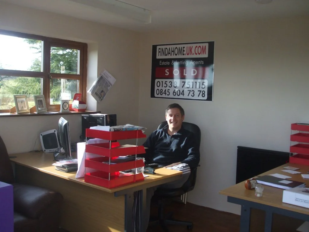 Tom Williams working from the original Findahome Online garden office in 2010 after launching the business in Stoke-on-Trent.