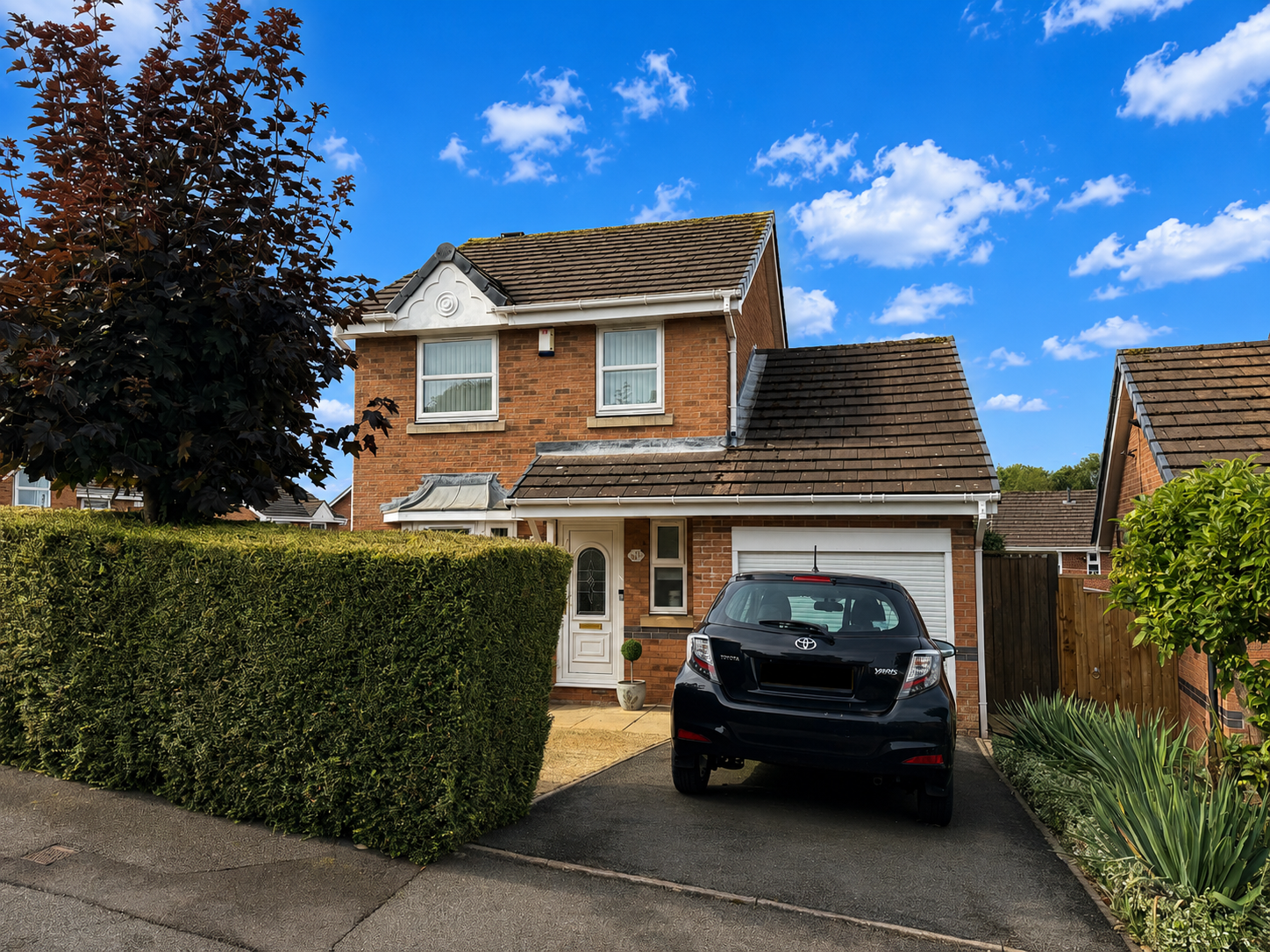 Front exterior of a beautifully presented three bedroom detached house on Perton Wood View, Blurton, with driveway, integral garage, mature gardens and large corner plot.