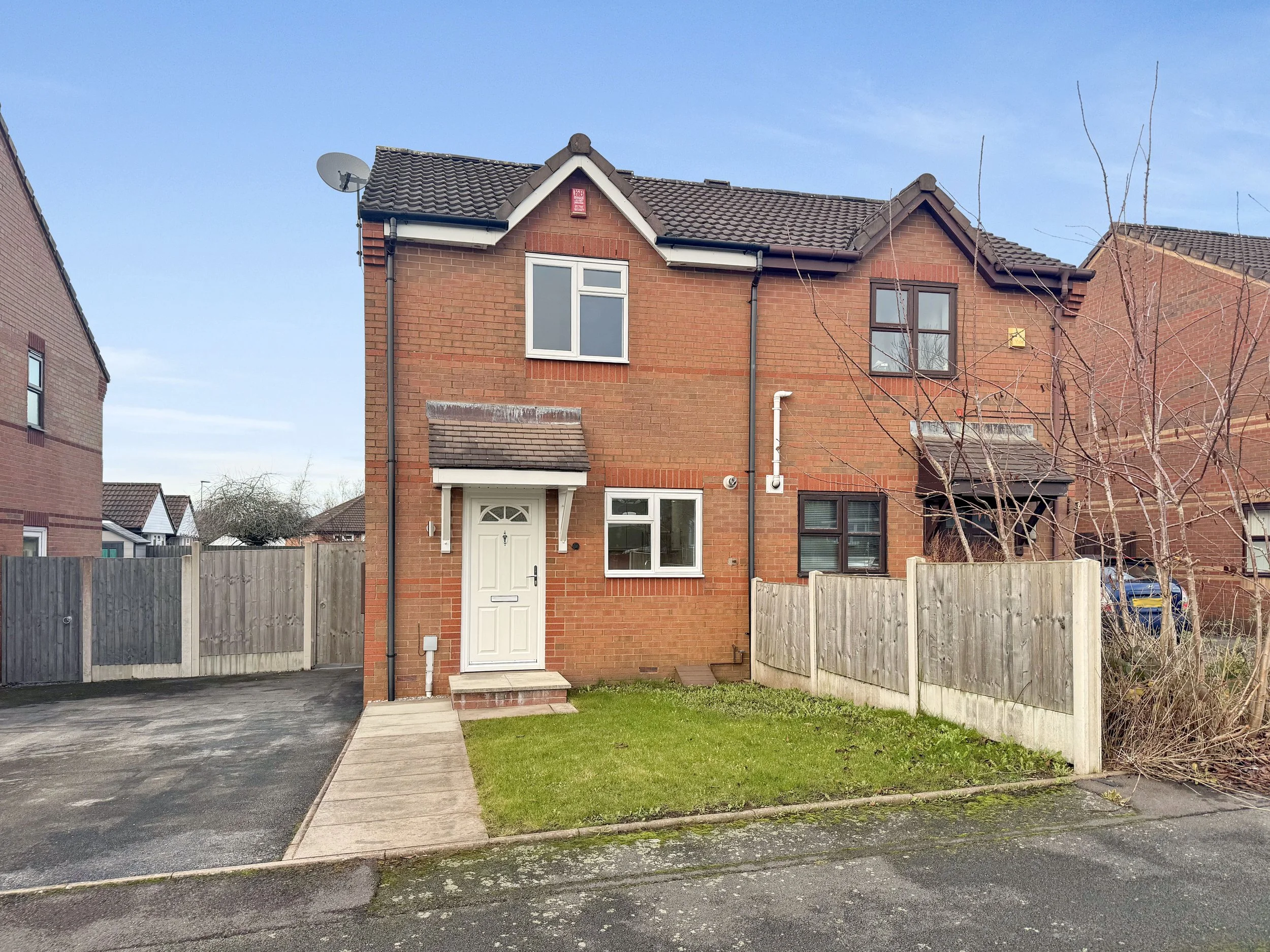 Front of the house on Banksman Road, Adderley Green showing driveway, front garden and blue sky