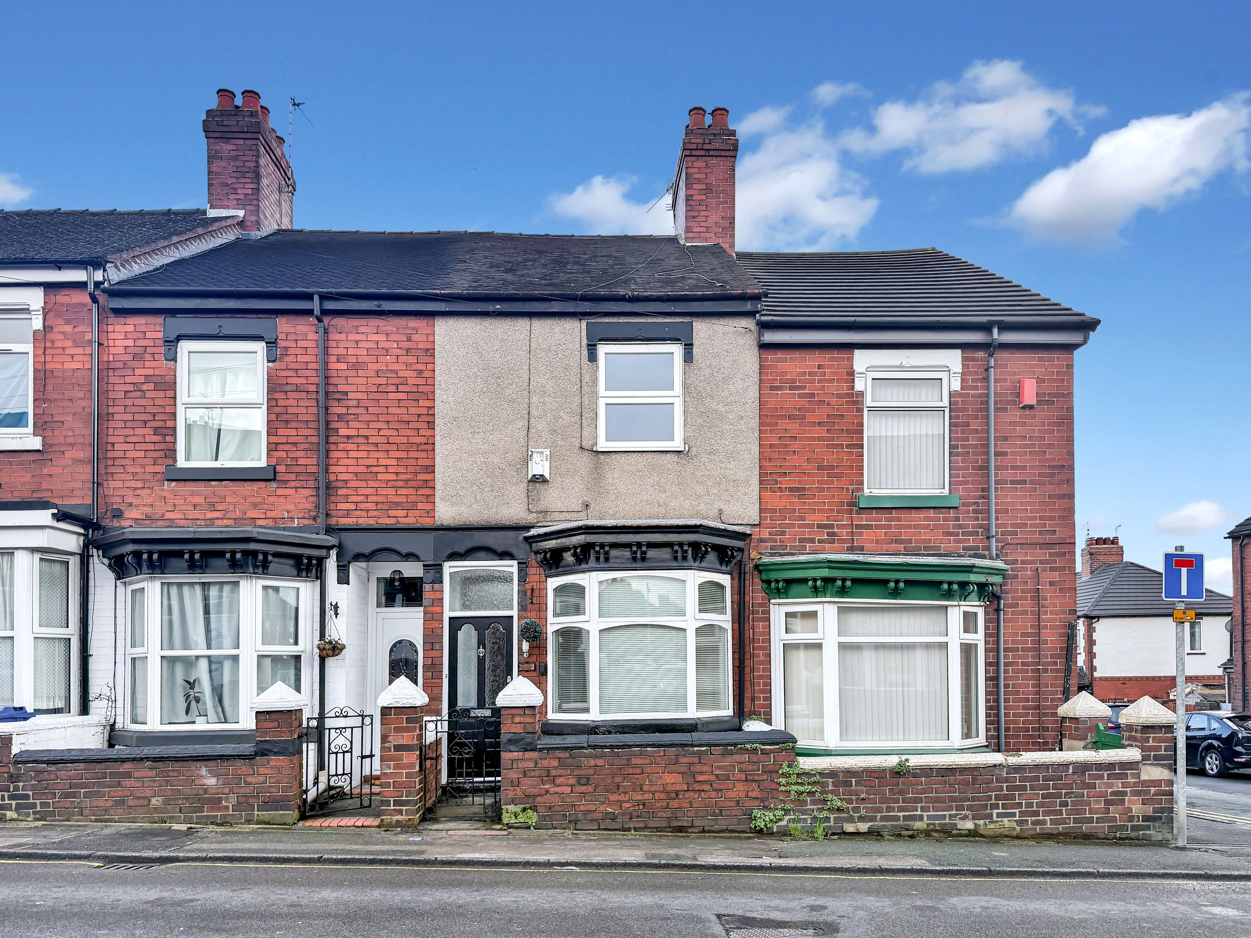 Front elevation of a two bedroom mid terraced house for sale on Watlands View, Porthill, Newcastle-under-Lyme with bay window and brick façade.