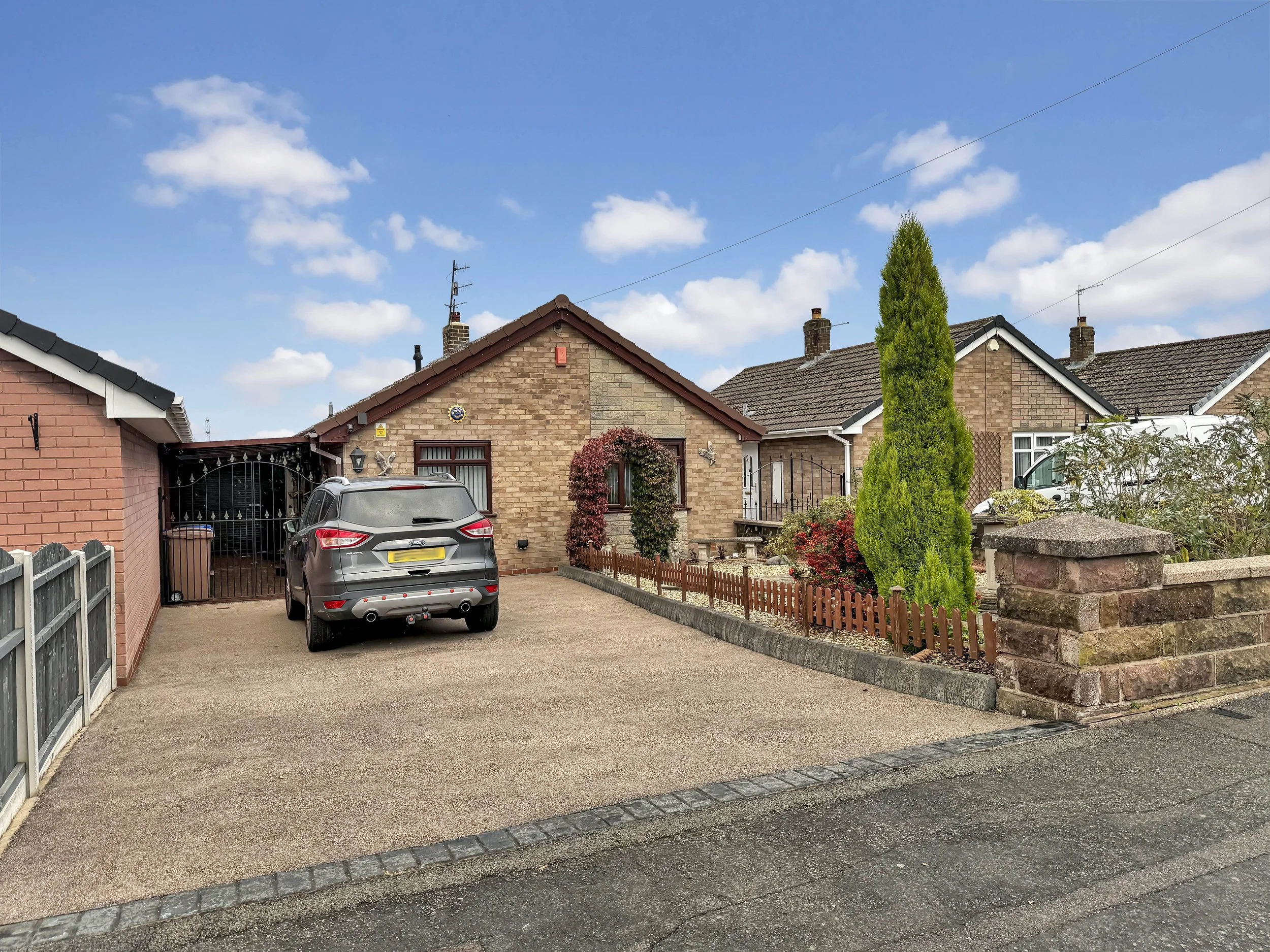 Front view of detached bungalow on Longnor Place, Eaton Park showing resin driveway, carport, and landscaped frontage.