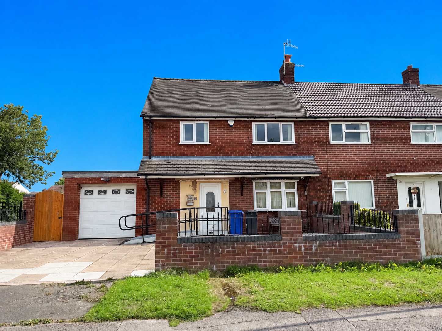 Front exterior of a three bedroom end town house for sale on Denry Crescent, Bradwell, Newcastle-under-Lyme, featuring a corner plot, driveway, integral garage and front garden.