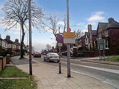 Entering Blurton Road from the A50 roundabout under a blue winter sky with retro 1990s cars, Blurton, Stoke-on-Trent