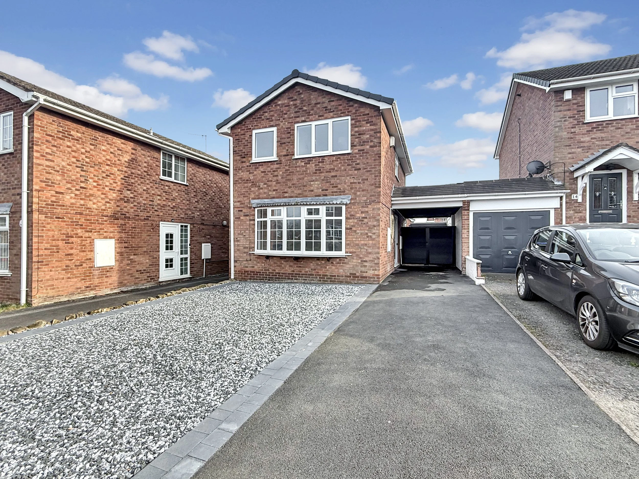 Front view of a newly renovated three bedroom detached brick house with driveway, gravelled front garden and garage in a quiet residential cul-de-sac in Trentham, Stoke-on-Trent.