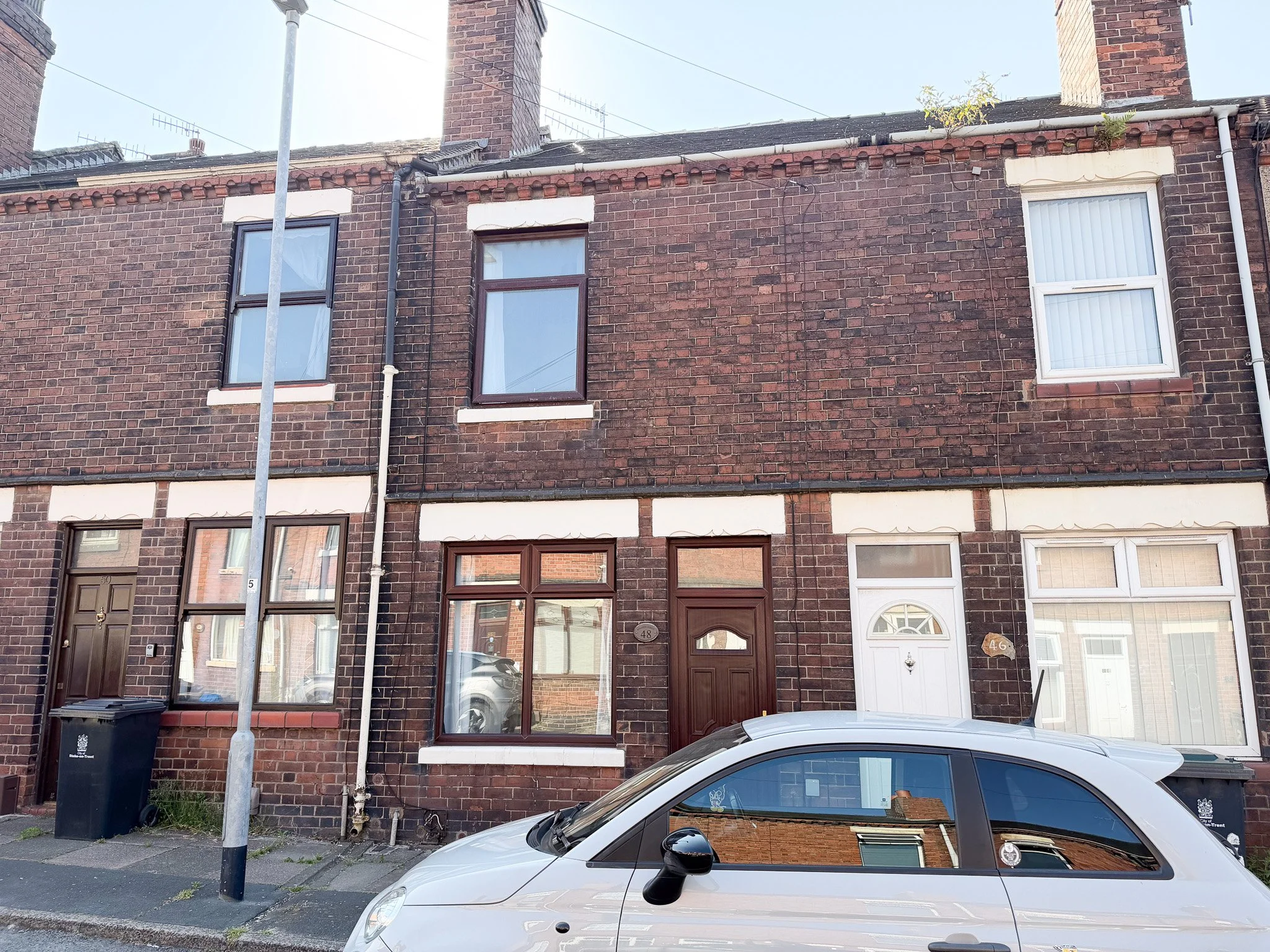 Front elevation of a two bedroom Victorian terraced house on Hollings Street, Fenton, Stoke-on-Trent with traditional brick façade and on-street parking.