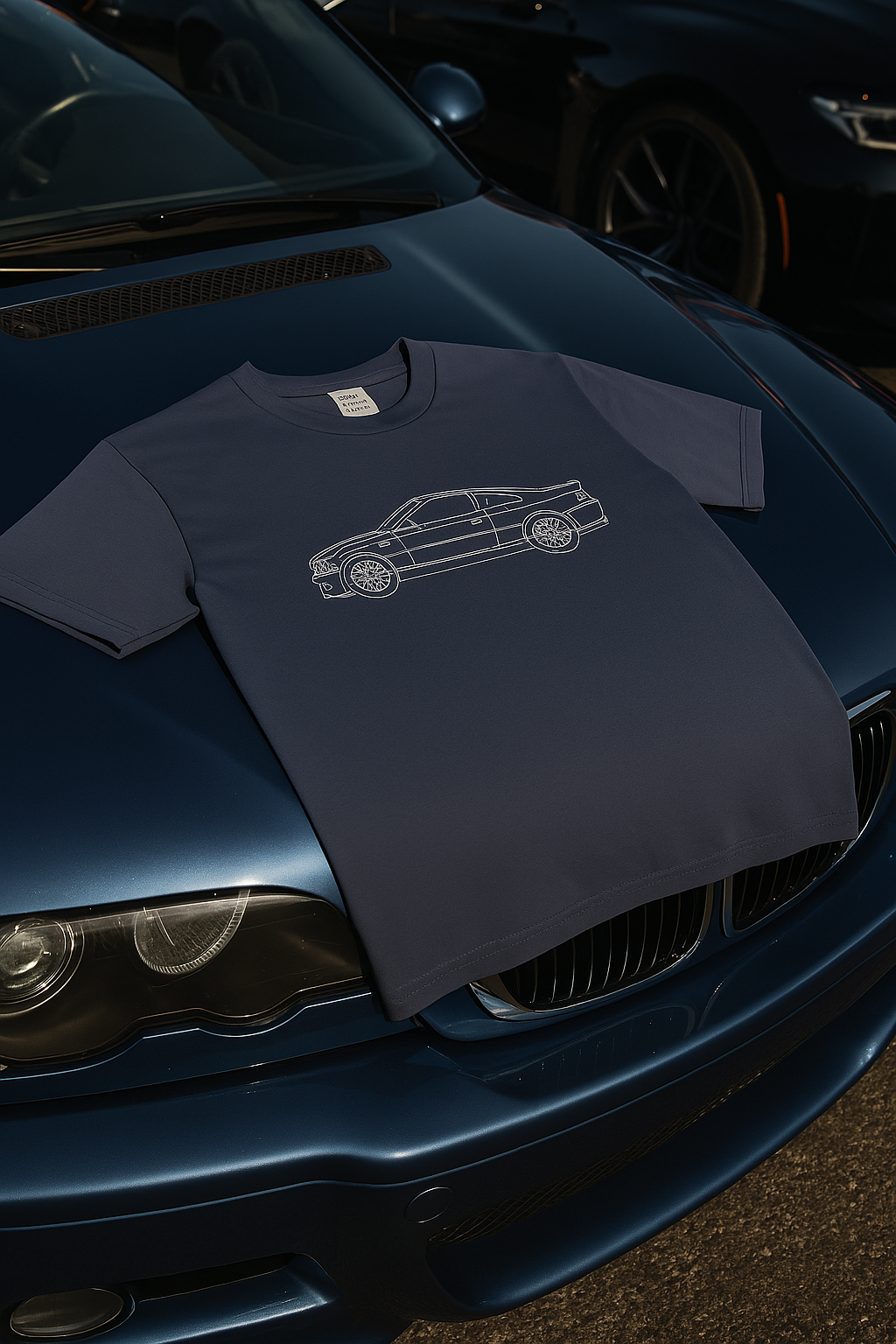 Navy blue T-shirt with car illustration on blue car hood