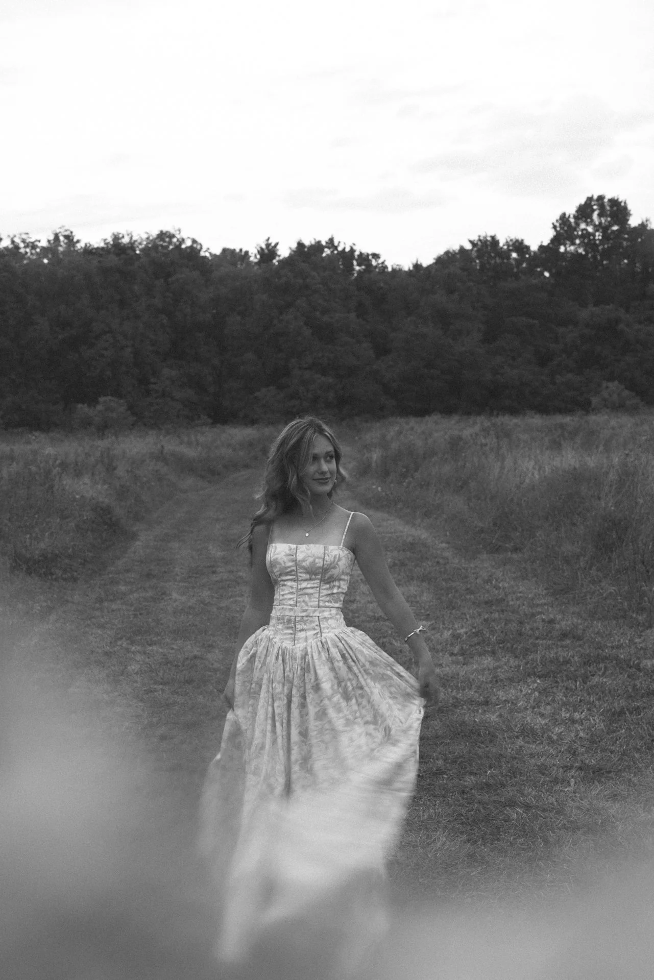 Senior girl walking in a field outdoors for a portrait session in morrow ohio for little miami schools.