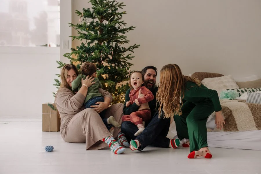 Christmas minis in Loveland ohio with a family of five laughing and hugging each other.