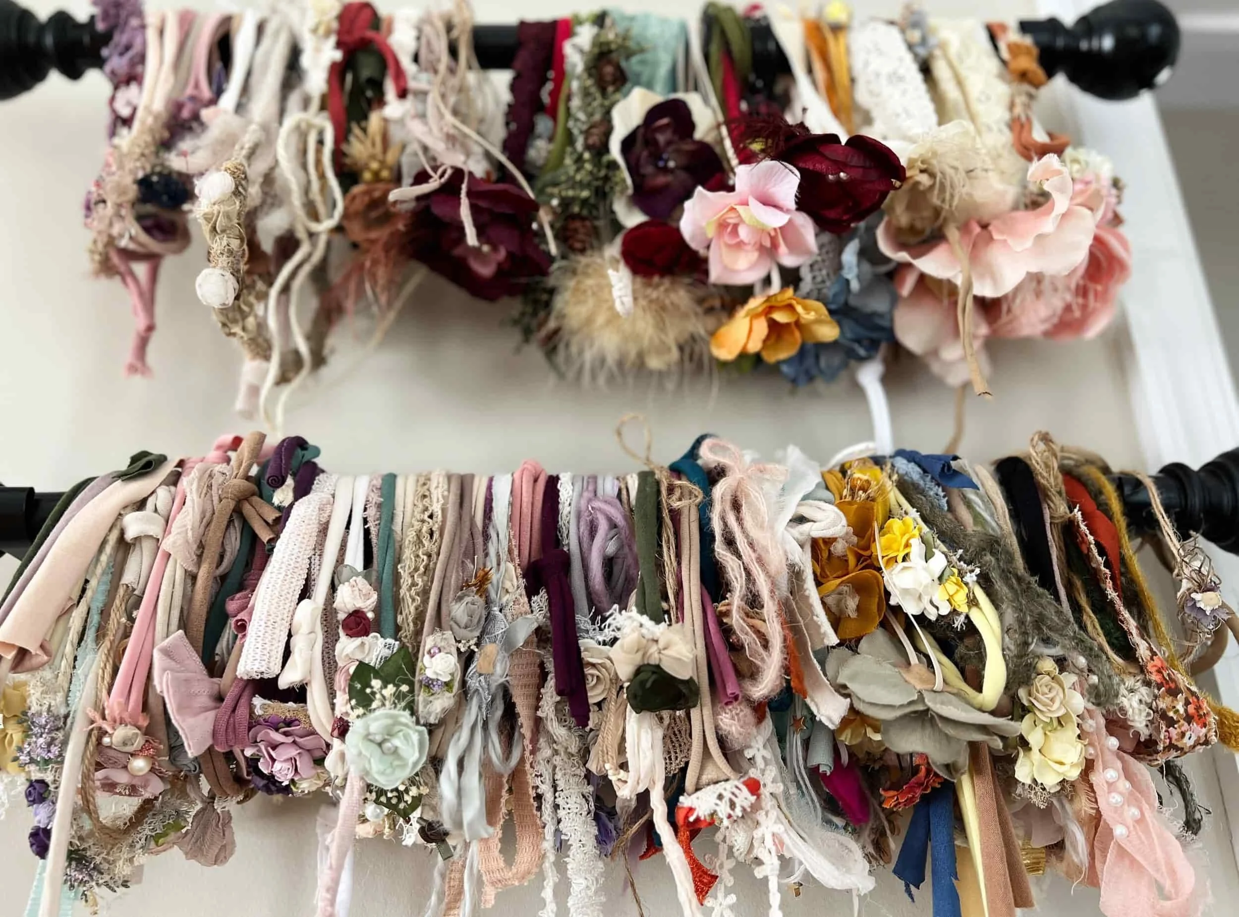 organized rows of newborn headbands and tiebacks for newborn photography session