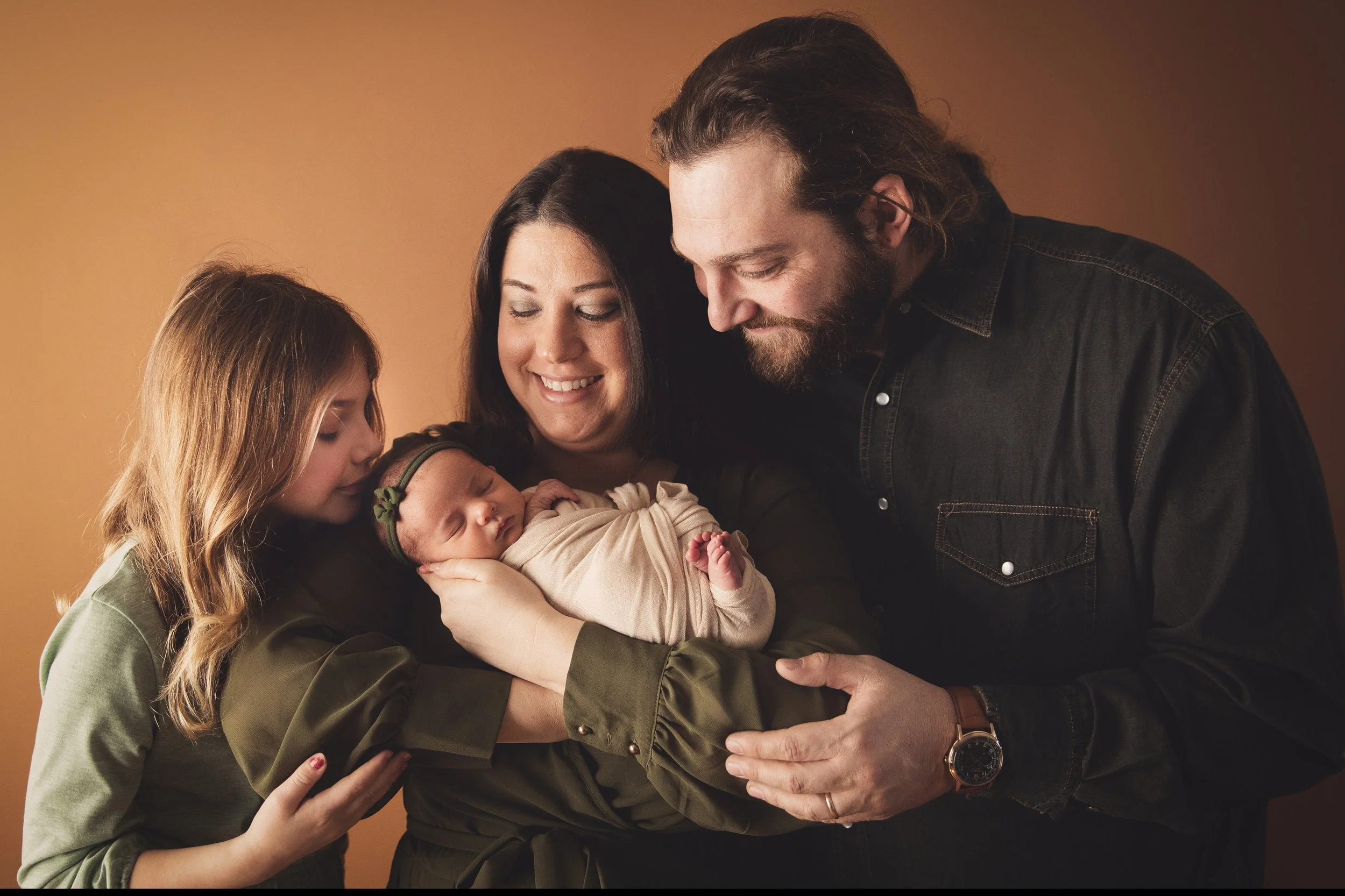 newborn family photography on mocha backdrop interacting with each other