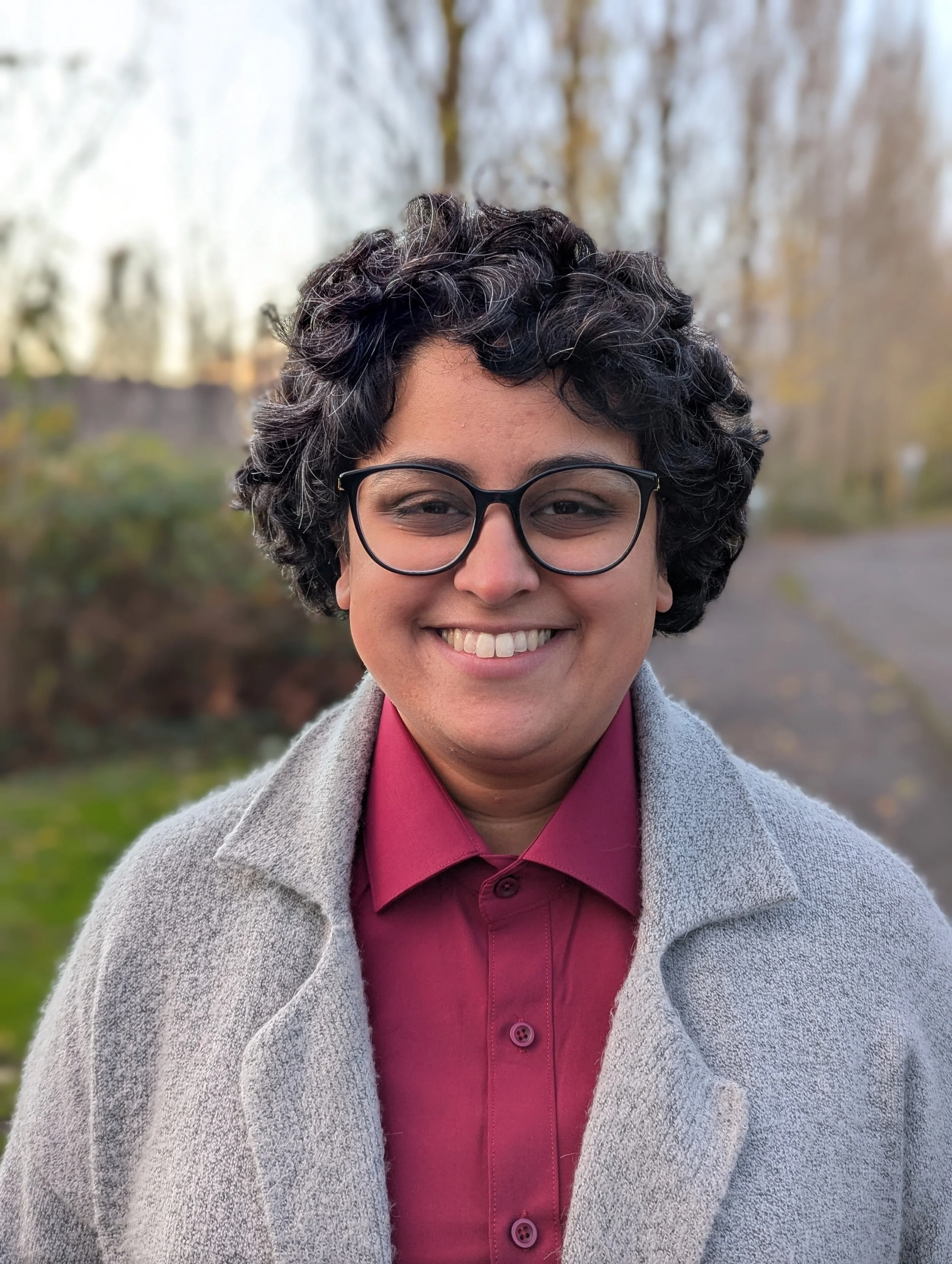 A photo of Harveer smiling at the camera.