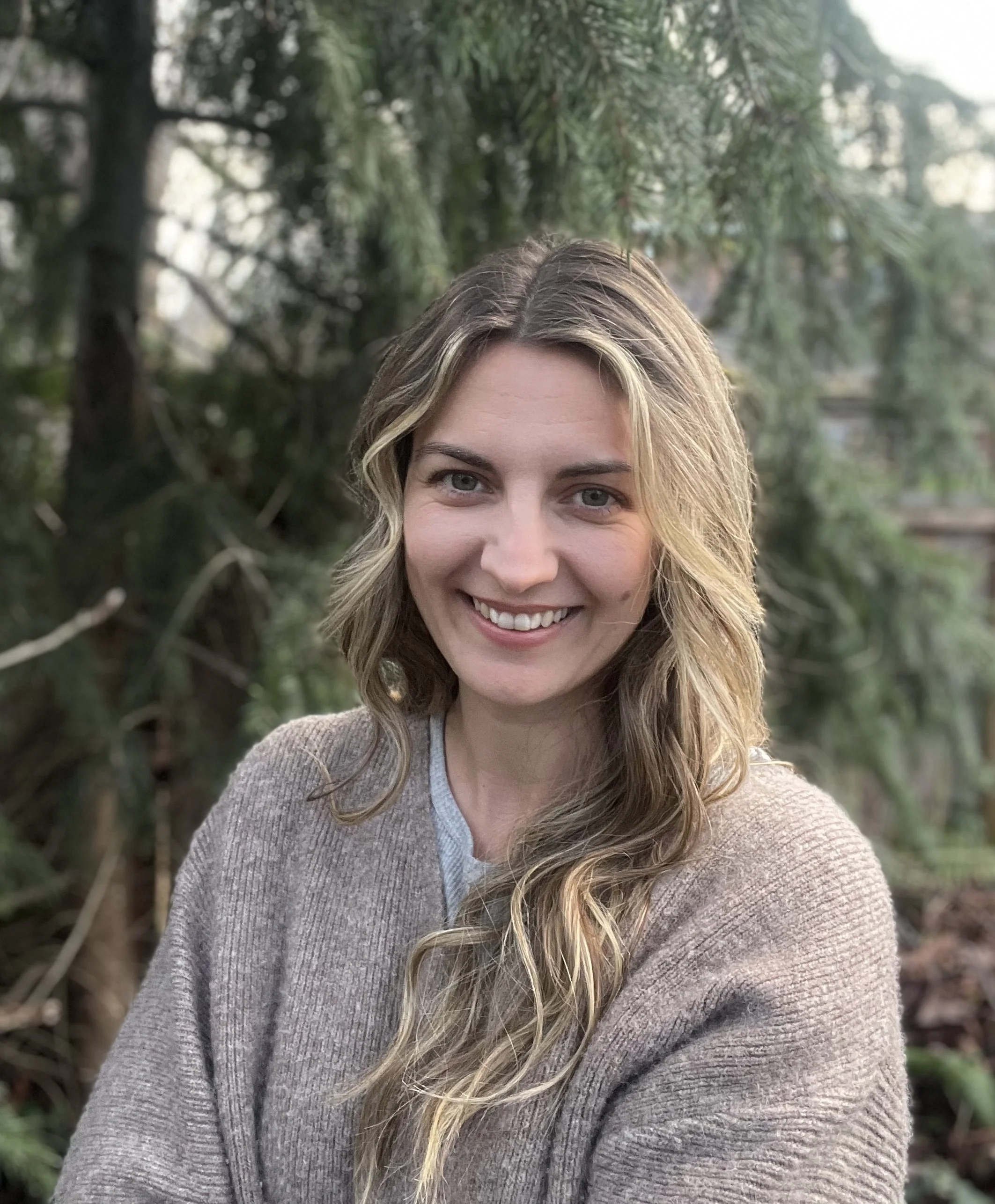 A photo of Sarah looking at the camera and smiling.
