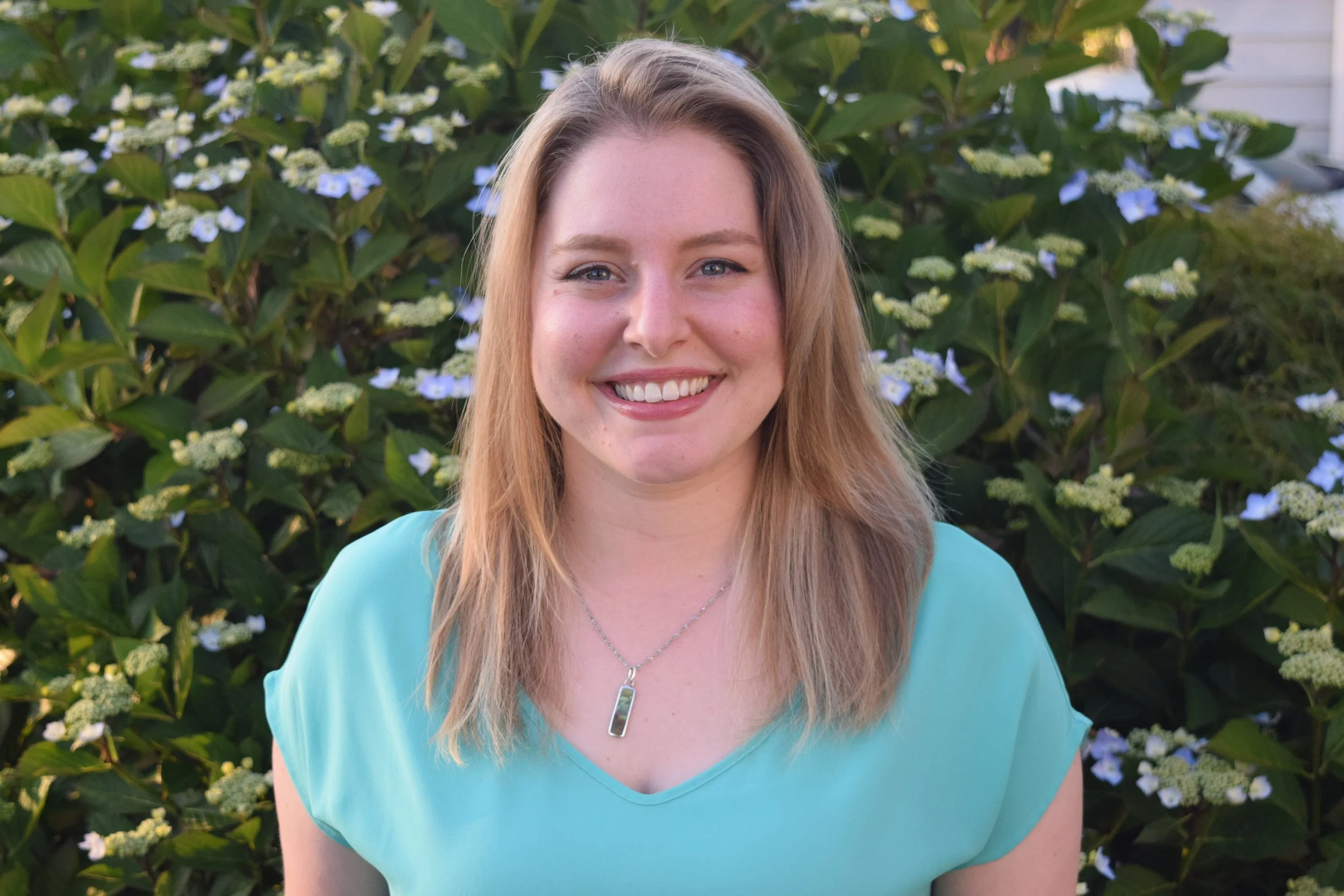 A photo of Justine looking at the camera and smiling.