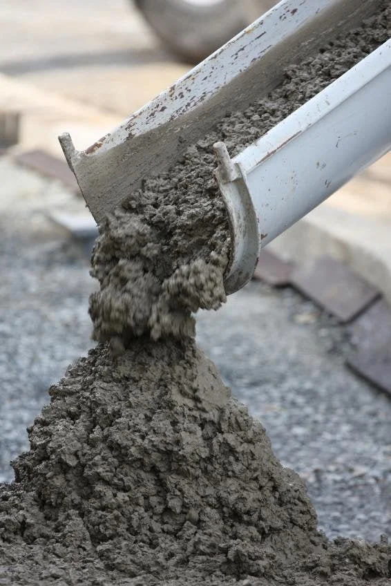 Raw concrete being poured and formed on site