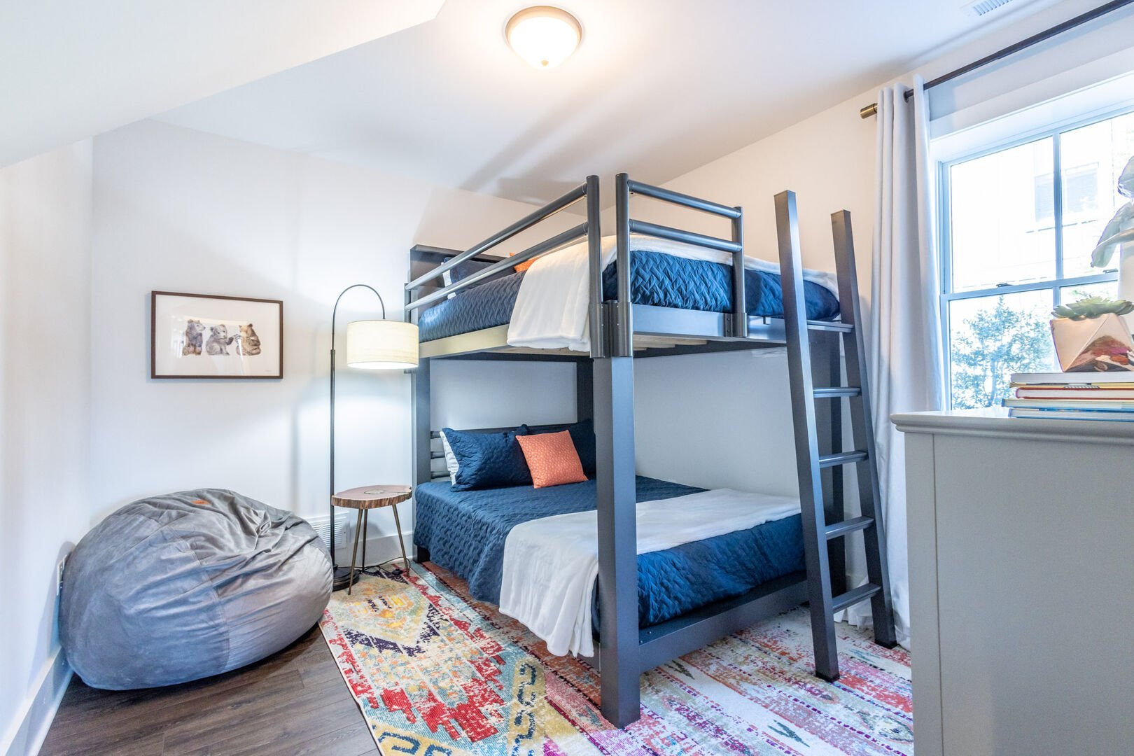 Queen-over-queen adult-sized bunks. Full size CordaRoy's bean bag also pictured (2 available).
