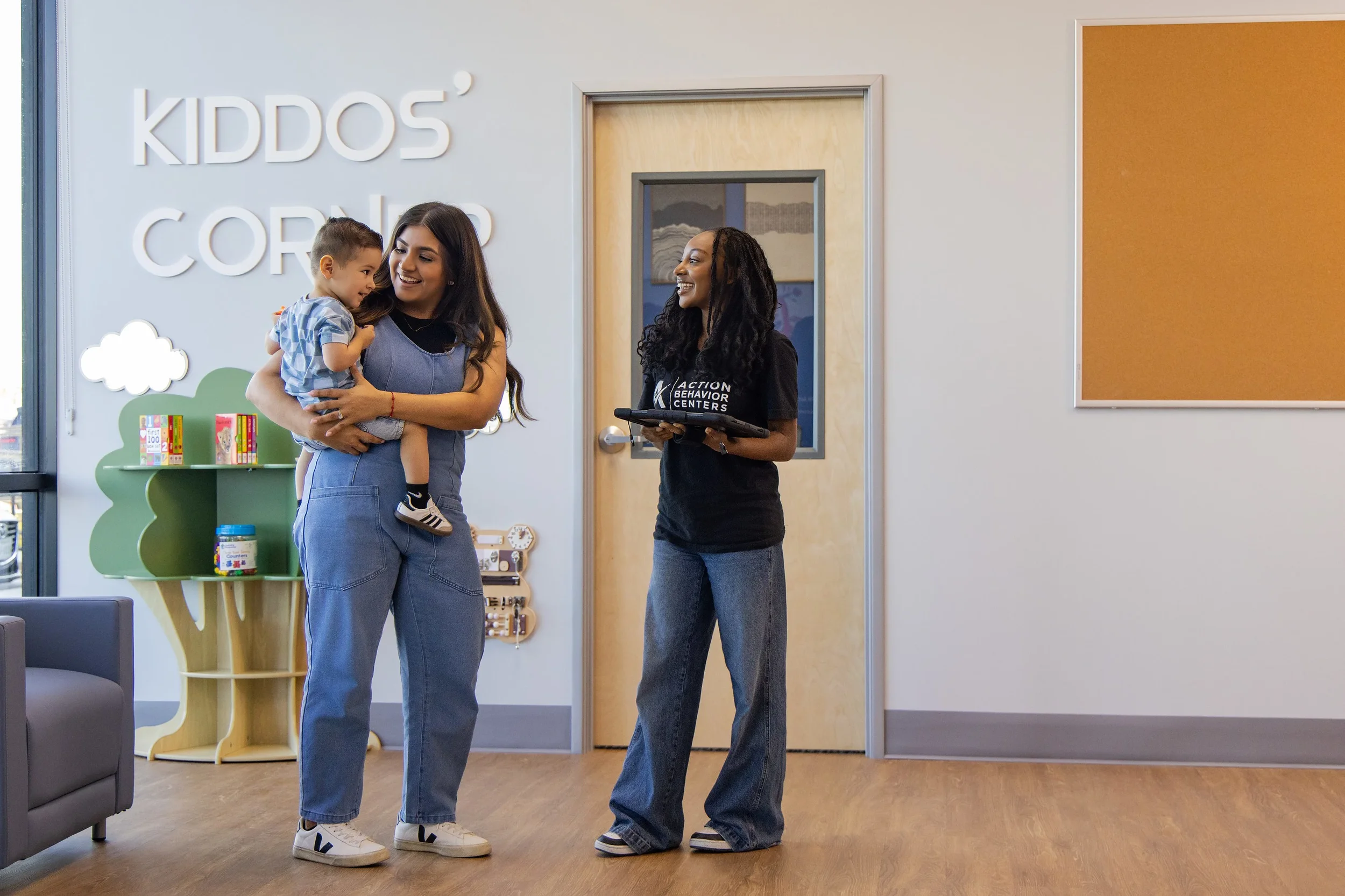 Therapist welcoming a parent and child in the lobby of Action Behavior Centers in San Antonio, creating a warm and inviting first impression.