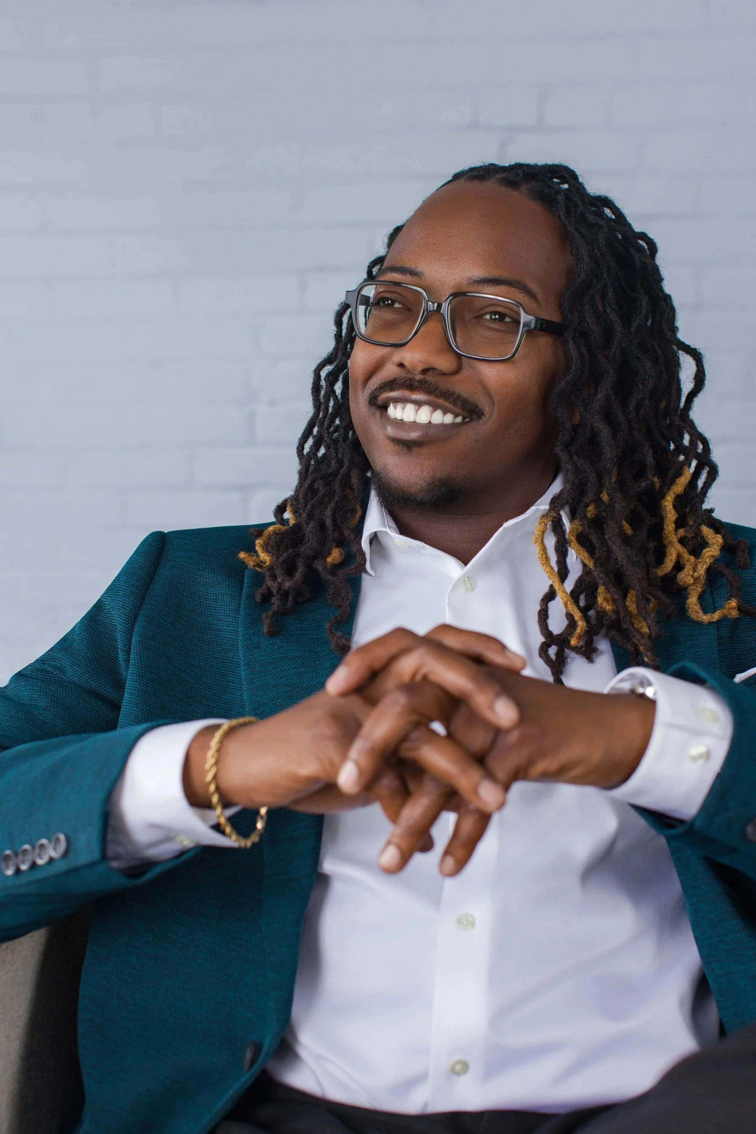 meet-the-bryants-san-antonio-texas-branding-portrait-man-locs-teal-blazer-commercial.webp