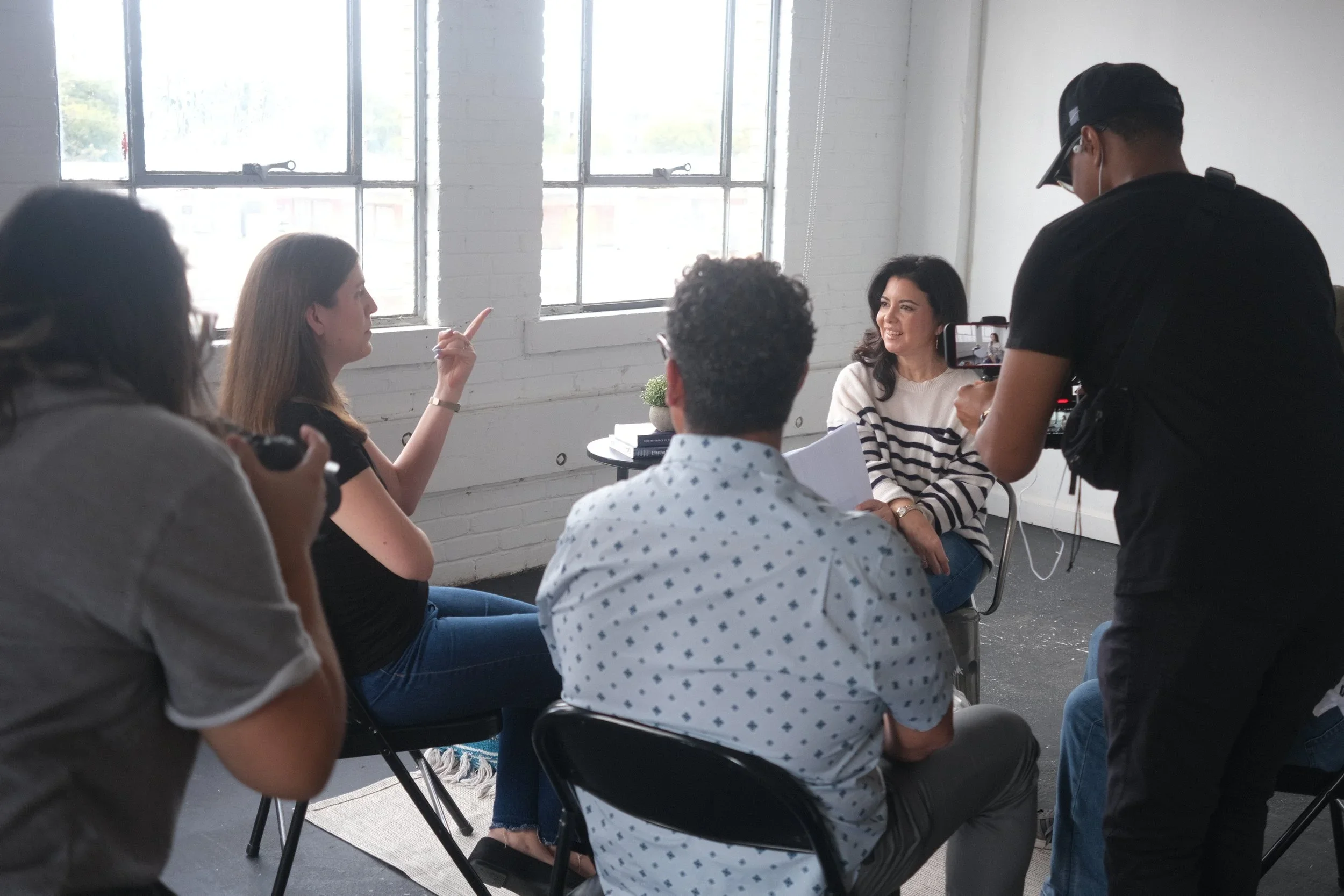 A candid look at the Meet the Bryants team in action, filming an interview with natural light streaming through studio windows, showcasing their collaborative approach to storytelling through photo and video.