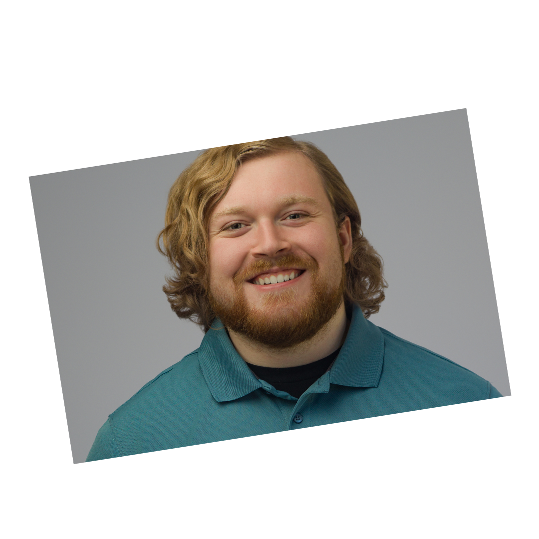 Modern professional headshot of a young man with a beard and teal shirt against a gray background