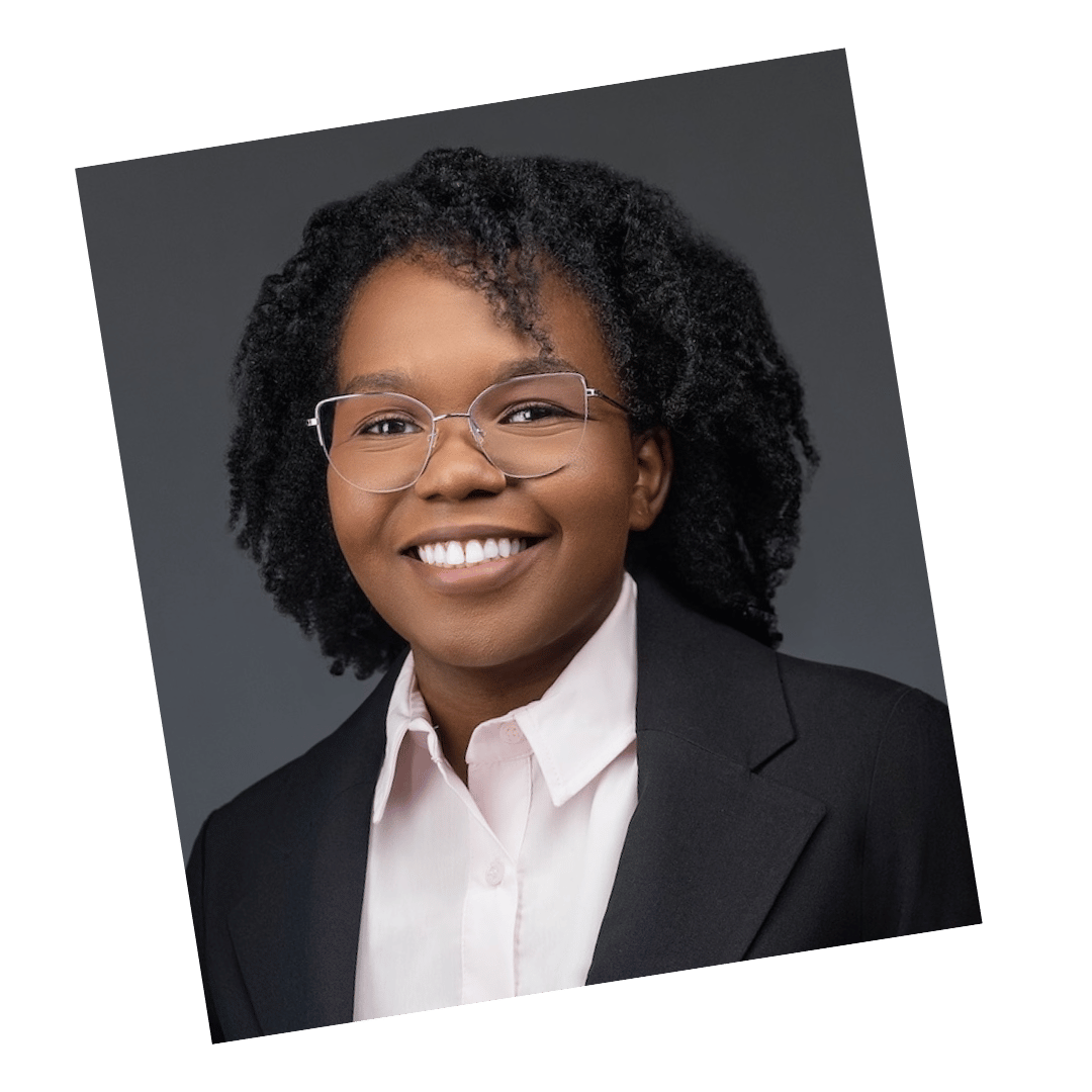Professional headshot of a woman with natural curly hair wearing glasses, a light pink shirt, and a black blazer, photographed by Meet the Bryants Photography in San Antonio, Texas