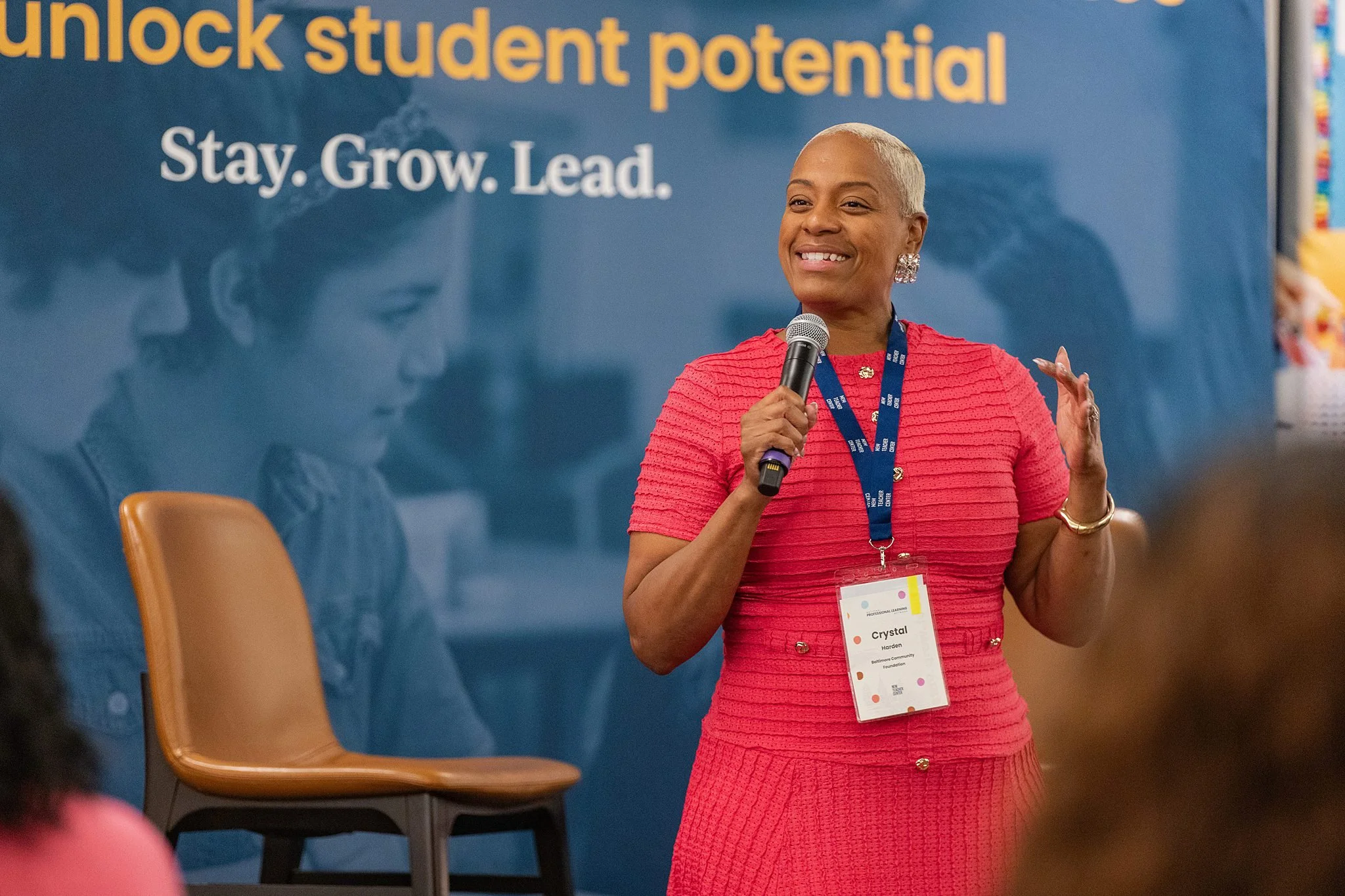 Conference speaker presents to attendees during an education leadership session.