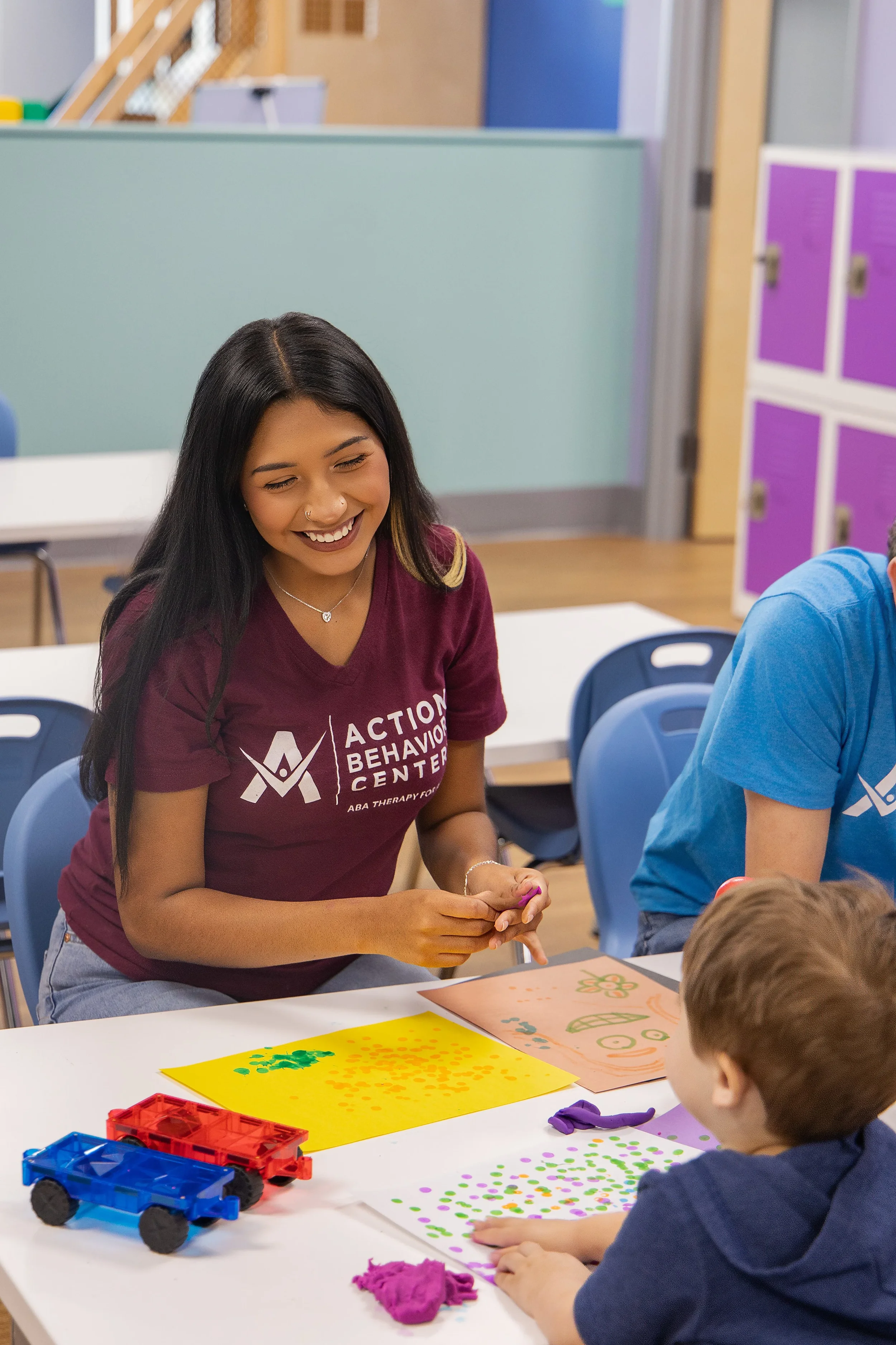Therapist working one-on-one with a child on creative play and communication skills at Action Behavior Centers in San Antonio, Texas.