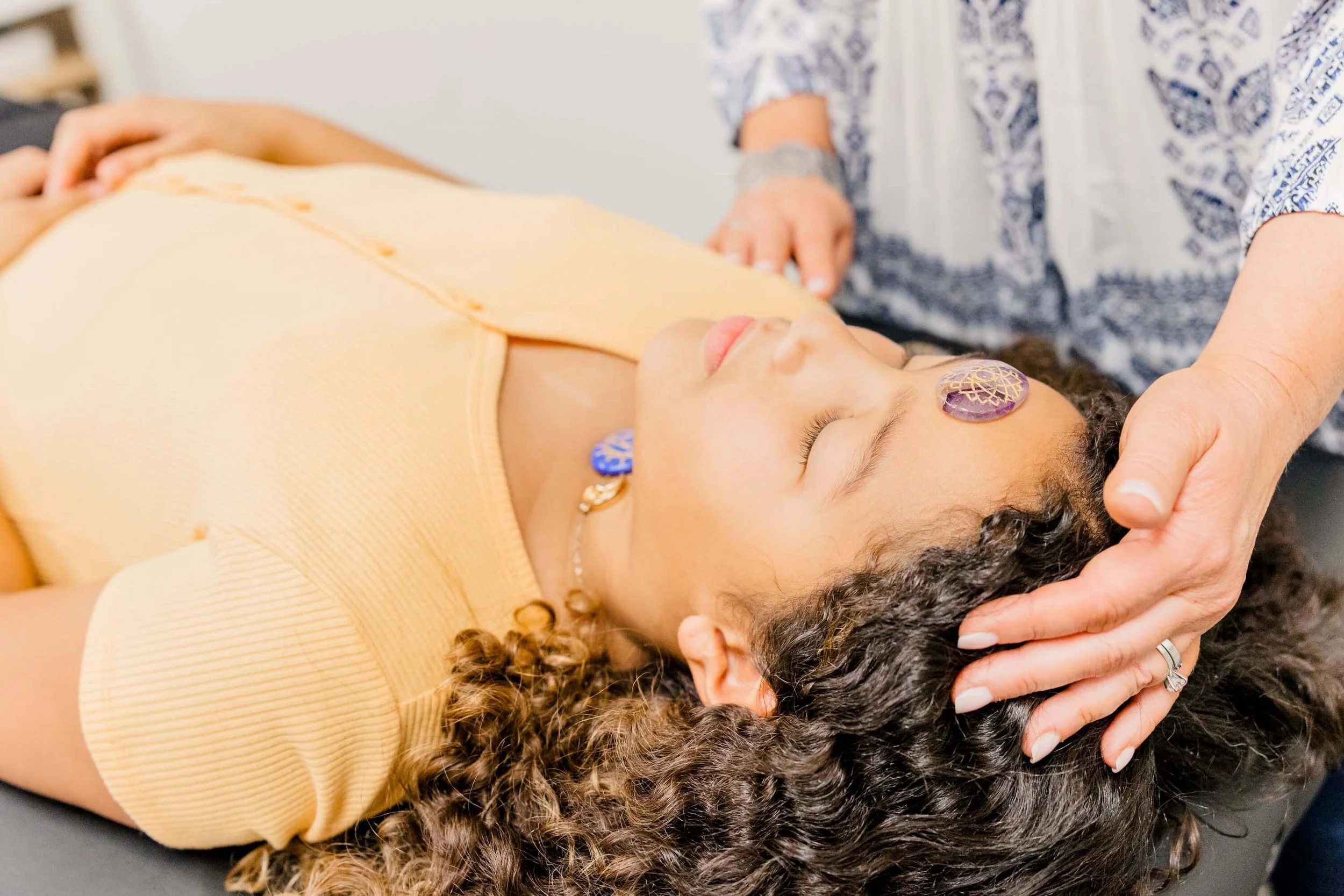 Jill Vetstein is in her reiki master office in natick, ma performing reiki on a child