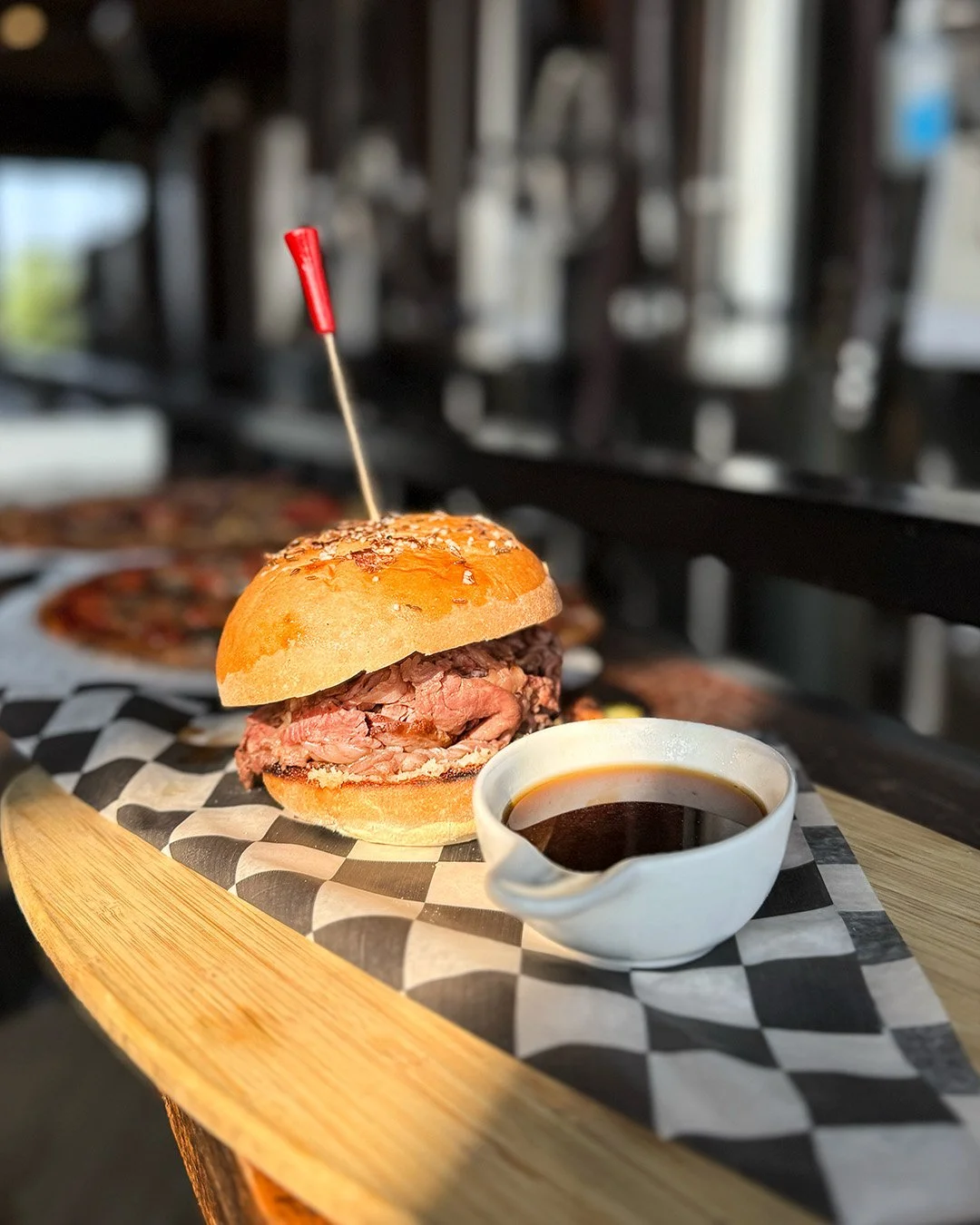 Roast beef sandwich piled high on a toasted roll with melted cheese, served at a Clifton Park, NY brewery