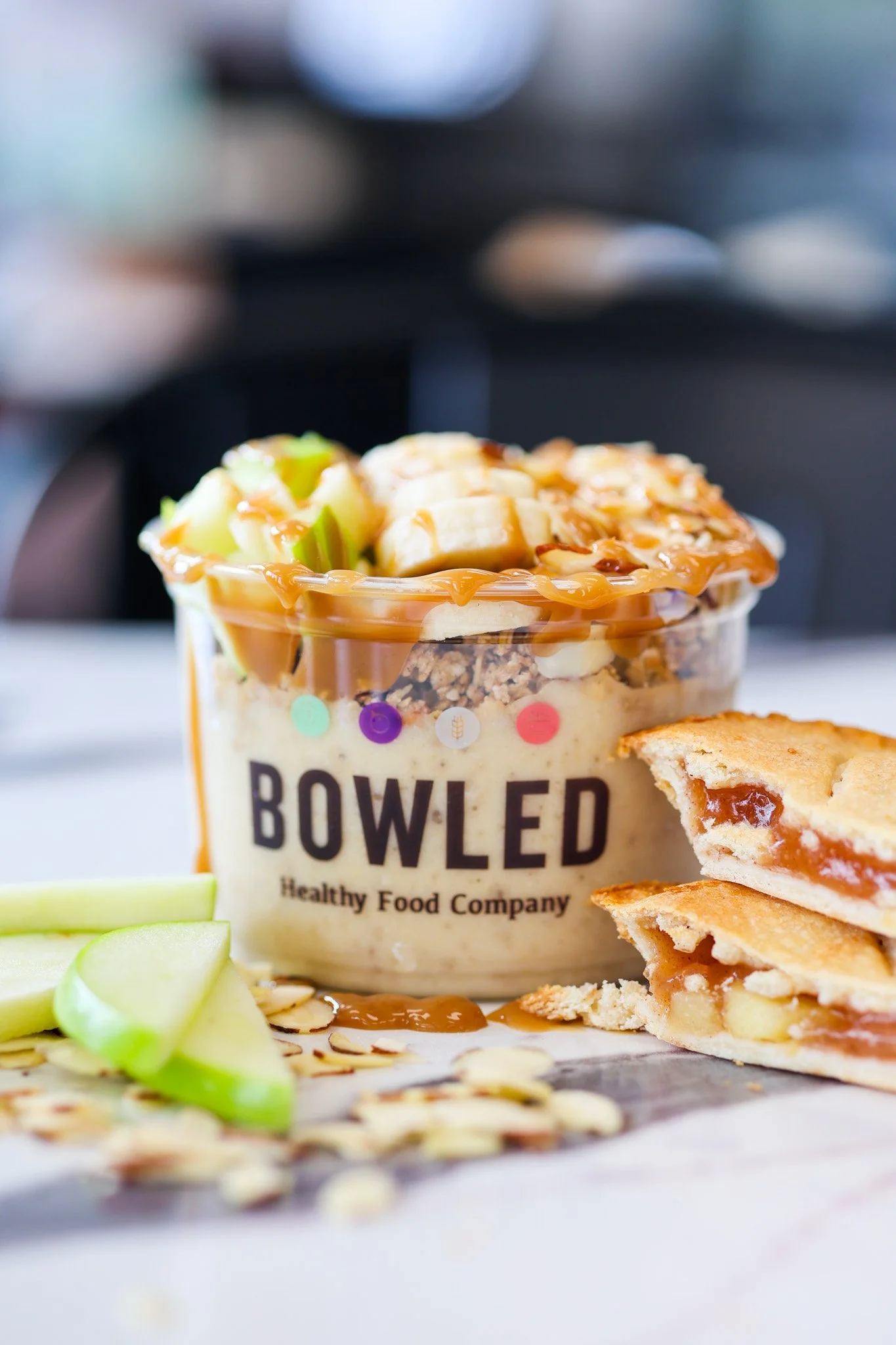Apple pie smoothie bowl topped with sliced apples, granola and a sprinkle of cinnamon, food photography for Sarasota, Florida