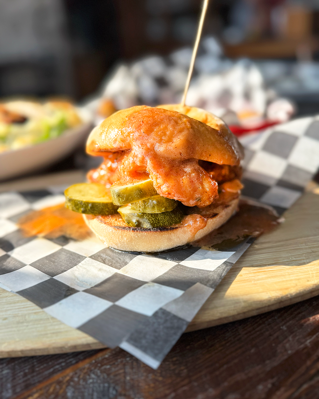 Stacked sandwich on a toasted roll served with chips at a Halfmoon, NY brewery, food photography for a local craft brewery