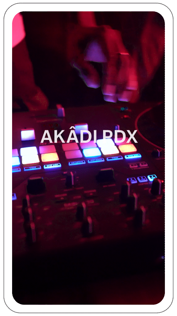 Close-up of a DJ mixer with illuminated buttons and a hand adjusting controls, under low red lighting with text 'AKÂDI PDX' overlayed on the image.