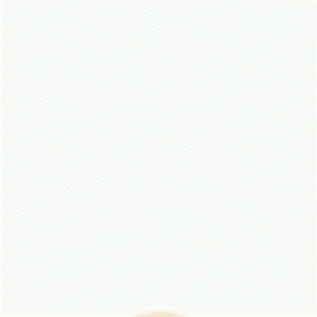 Golden retriever dog relaxing on a white bed with a tennis ball.