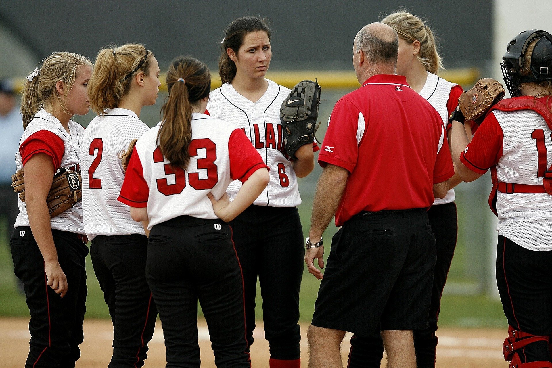 Coach speaking with softball team