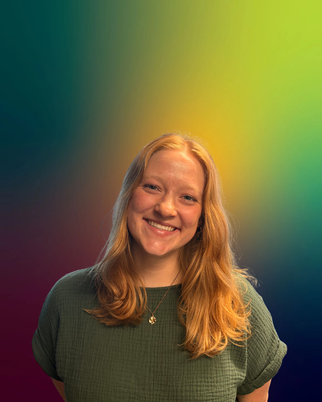 Smiling Laurie wearing black with a colorful gradient background.