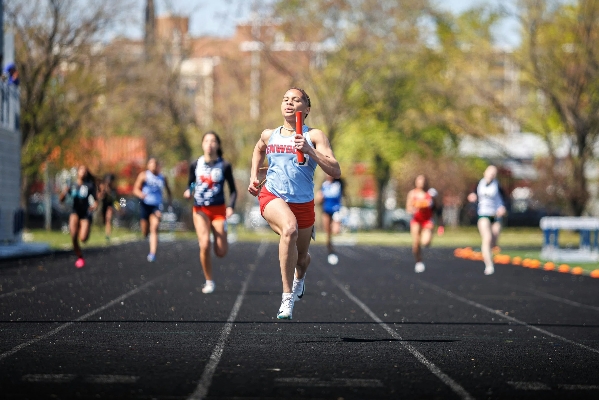 person running holding a baton