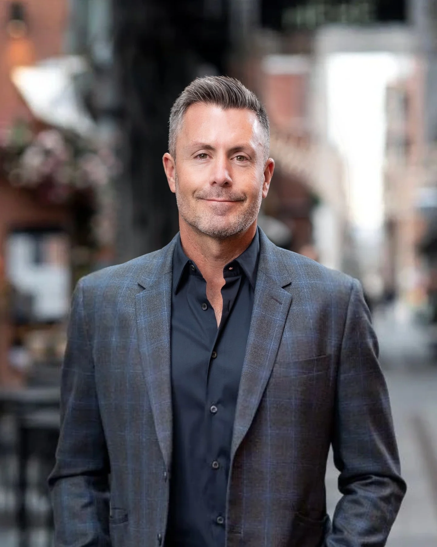 Chad McWhinney, co-founder of Realberry, in a gray plaid blazer and navy shirt