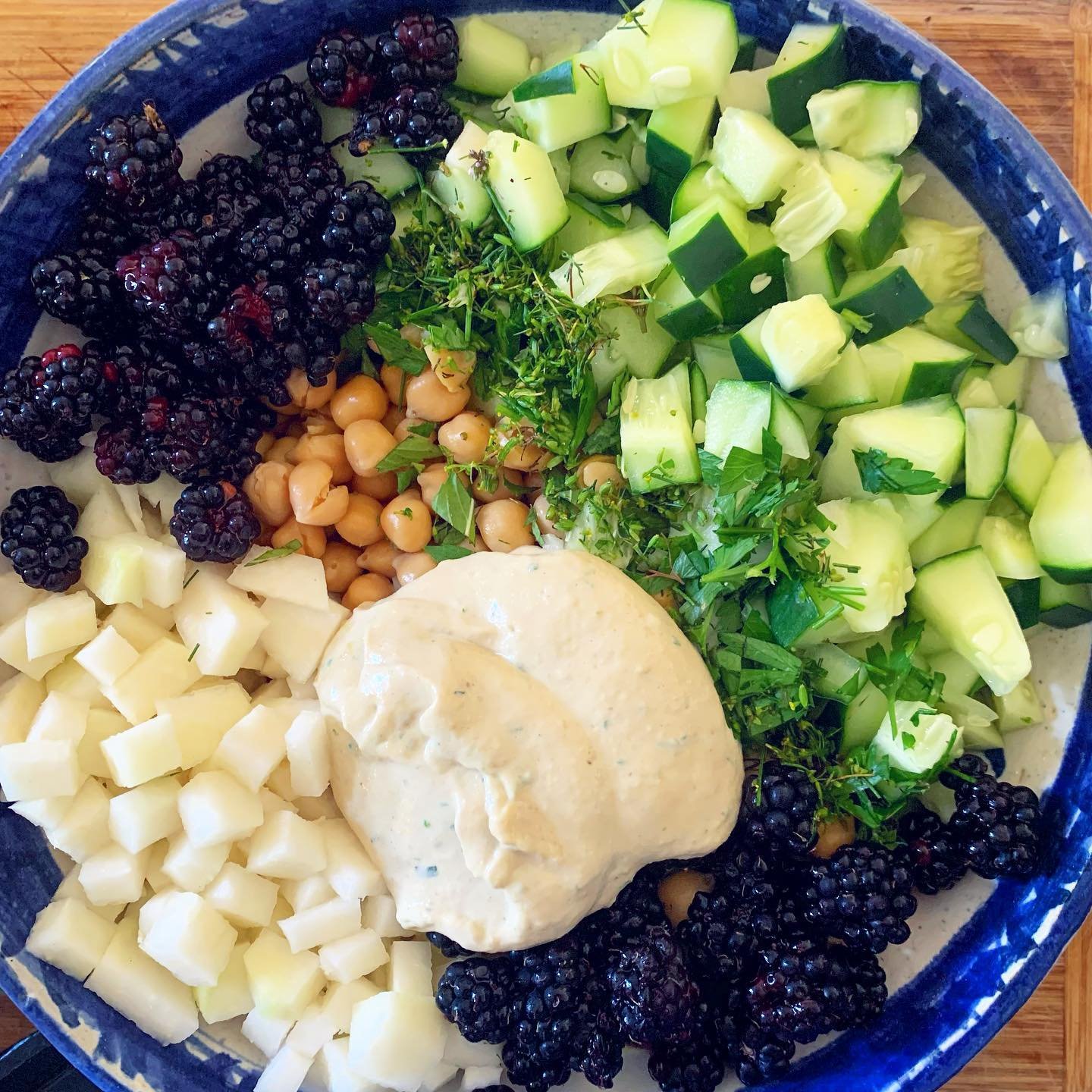 Currently eating my feelings with this seasonal salad inspired by the cucumber chickpea salad with lemon herbed tahini sauce shared by @andreabemis. I used kohlrabi instead of radishes, topped it with blackberries to entice the kiddos to eat it, swap