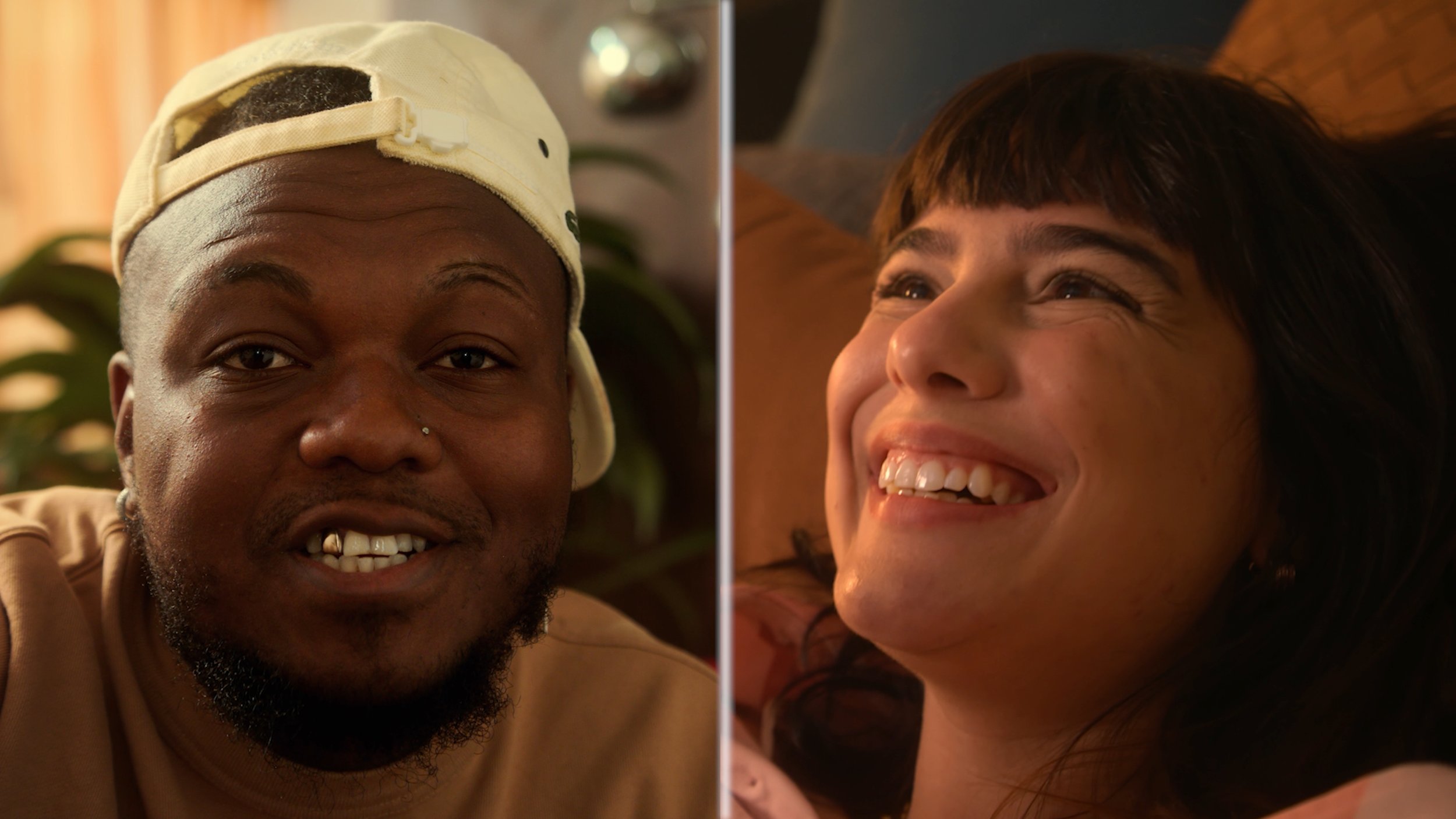 Side-by-side images of a man and a woman smiling. The man has a beard, pierced nose, and is wearing a baseball cap backwards. The woman has dark hair with bangs and is lying back, smiling brightly.