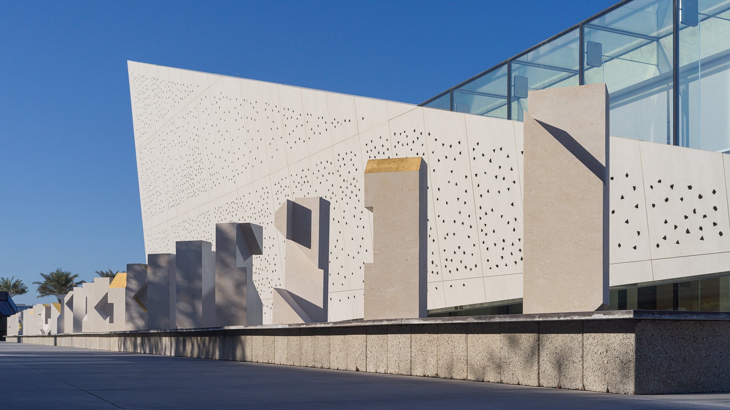 Tarek Elkassouf طارق القاصوف — Boundaries, a large-scale public art installation at Bassam Freiha Art Foundation, Abu Dhabi. This monumental UAE sculpture series features 29 hand-carved limestone and 22k gold leaf