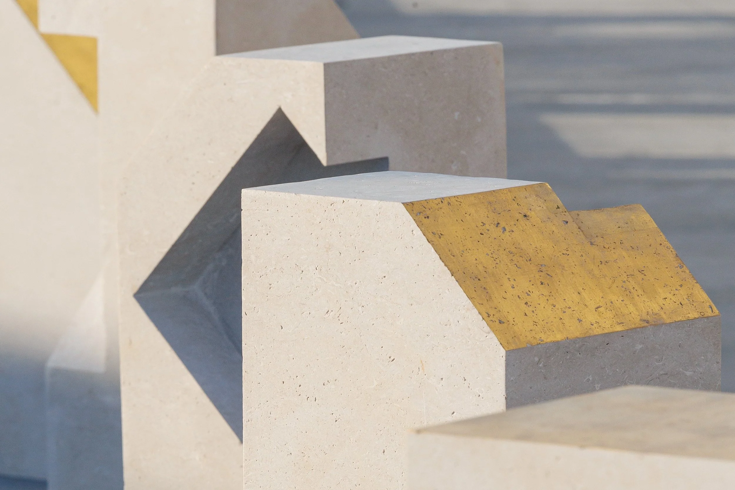 Tarek Elkassouf طارق القاصوف — Boundaries, a large-scale public art installation at Bassam Freiha Art Foundation, Abu Dhabi. This monumental UAE sculpture series features 29 hand-carved limestone and 22k gold leaf
