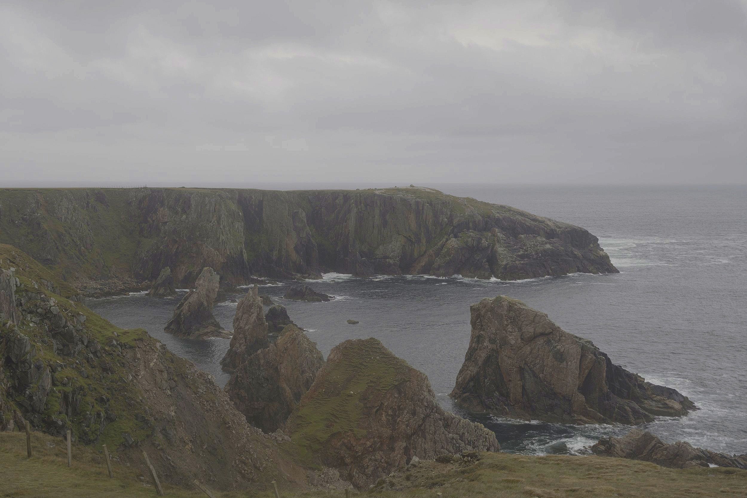 "The sand leads toward rugged cliffs, and tree-covered hills beyond."
(p20)