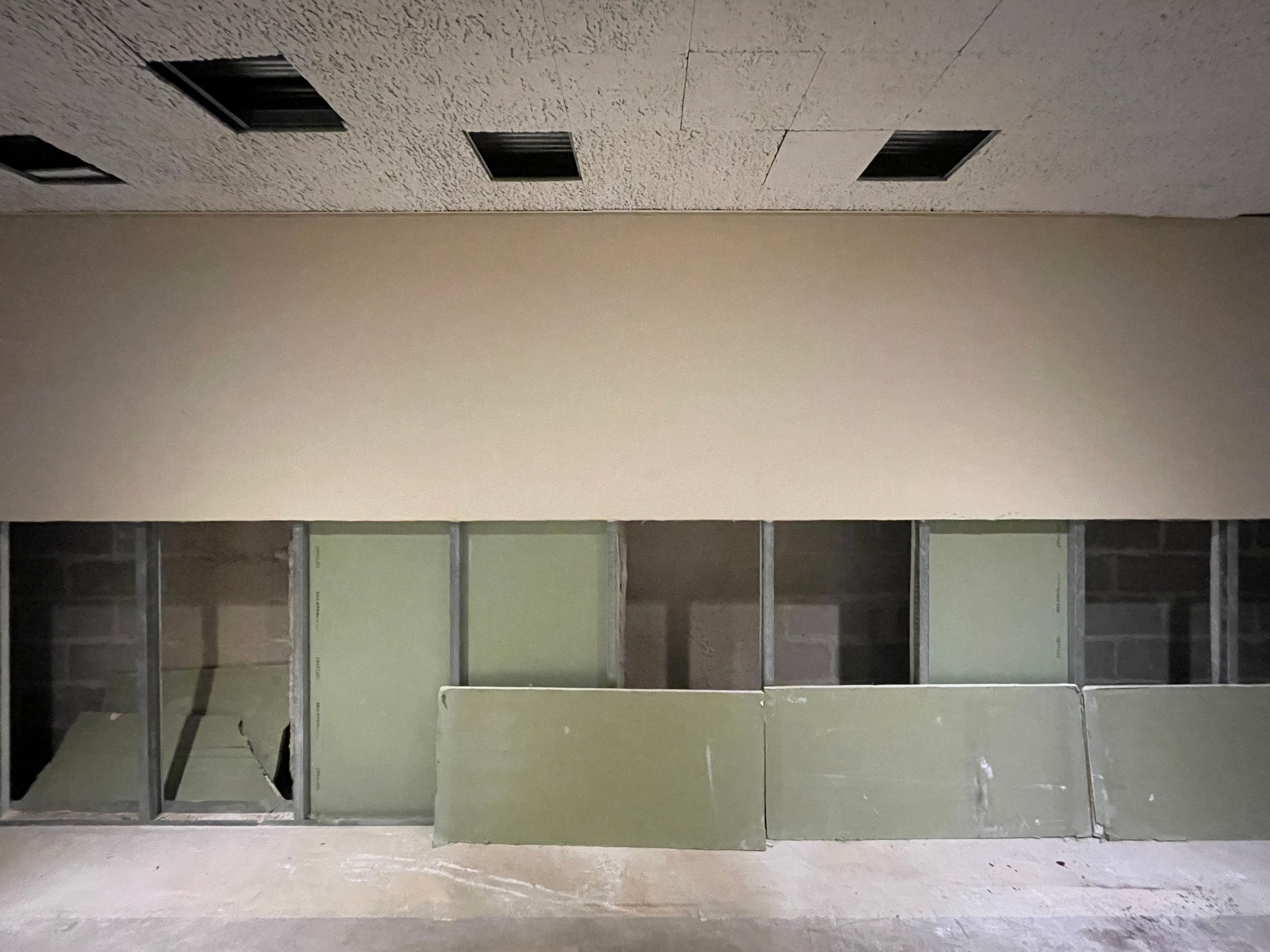 A before picture of the Theatre at Saint Peter's Lobby: flood cuts and bare floors are visible as we prepare for construction to update and repair this area.