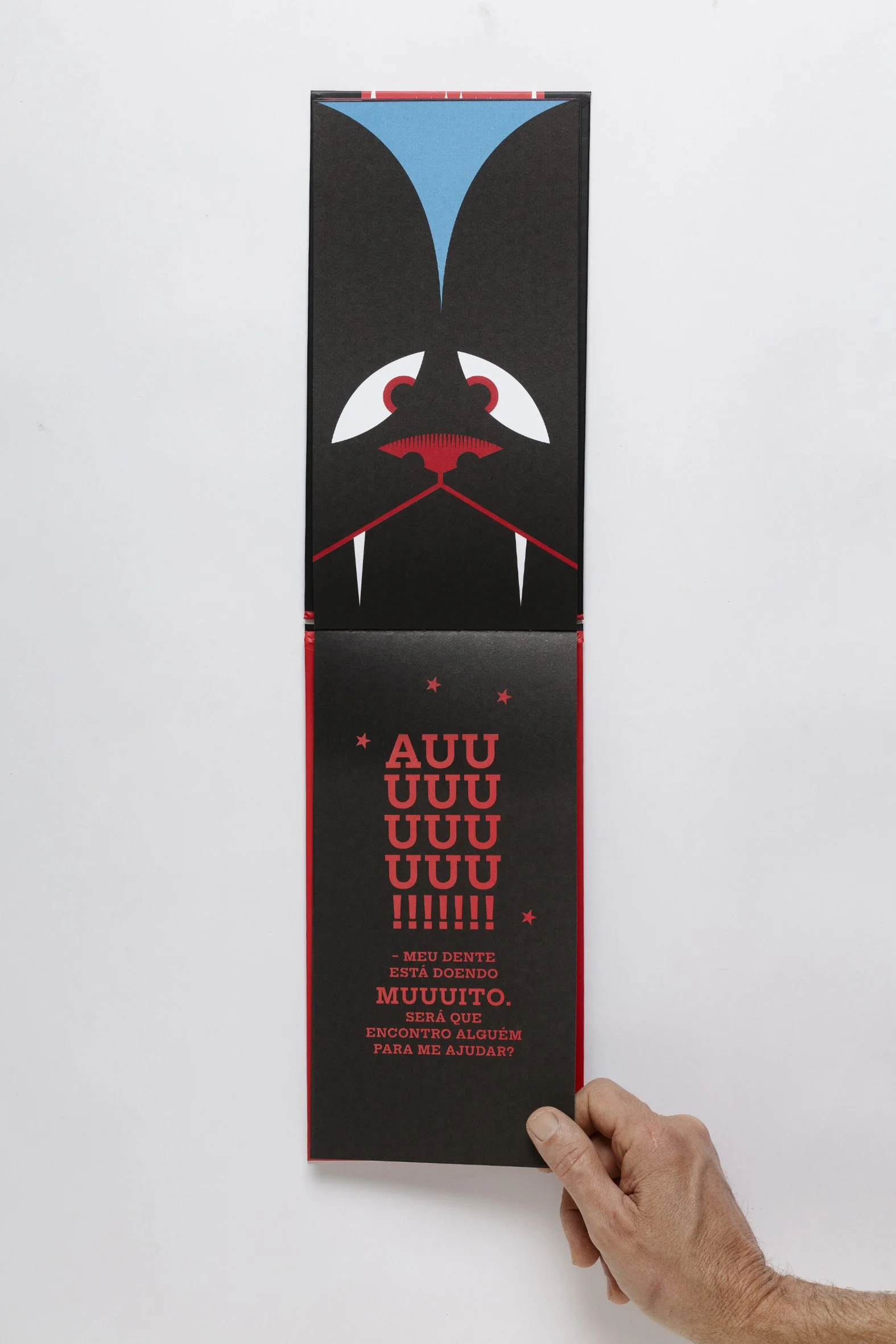 Reader’s hand interacting with a die-cut picturebook, activating the narrative through page turning