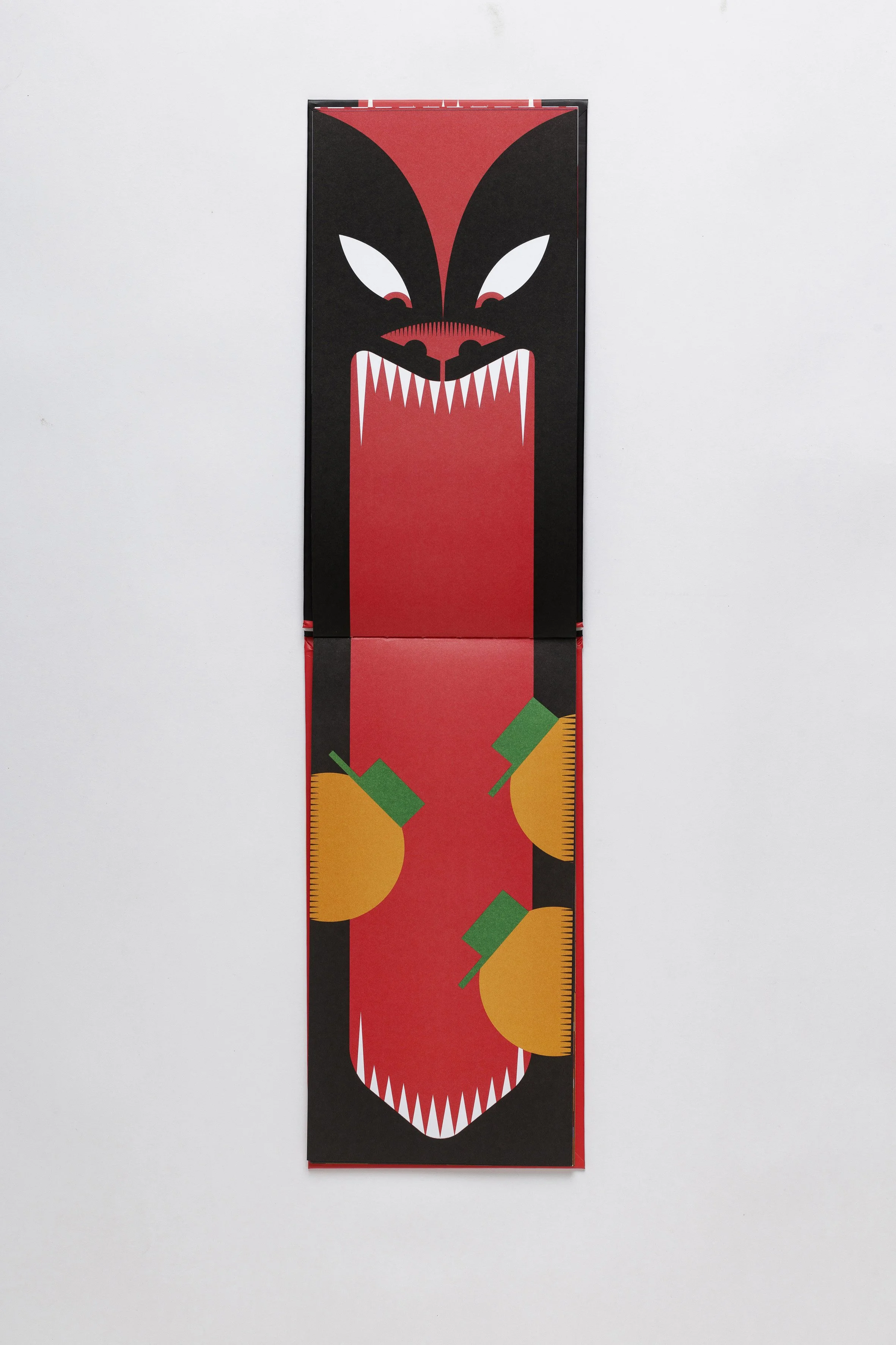 Stylized wolf face in a die-cut picturebook emphasizing vertical reading gesture