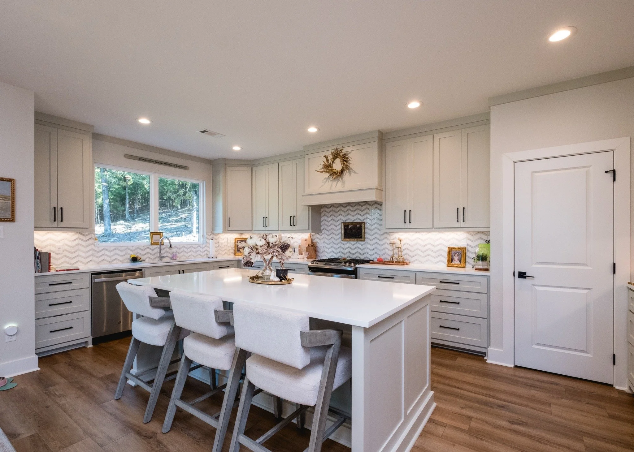 19016 Waterview Meadow Lane | Features you'll fall for: large, unobstructed windows (so much light!). An expansive entry and balanced porch with seating space. Airy neutrals in every room, with layered textures and special extras. Trees across the ba